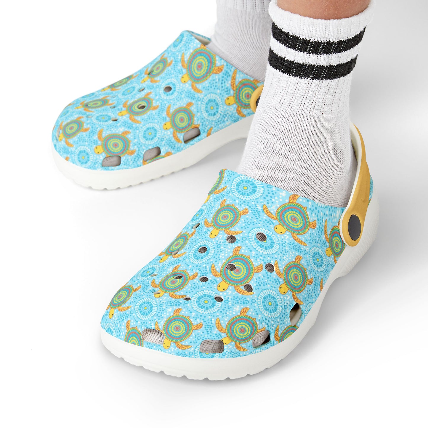 Light blue turtle-pattern clog shoes worn with white socks and black striped cuffs