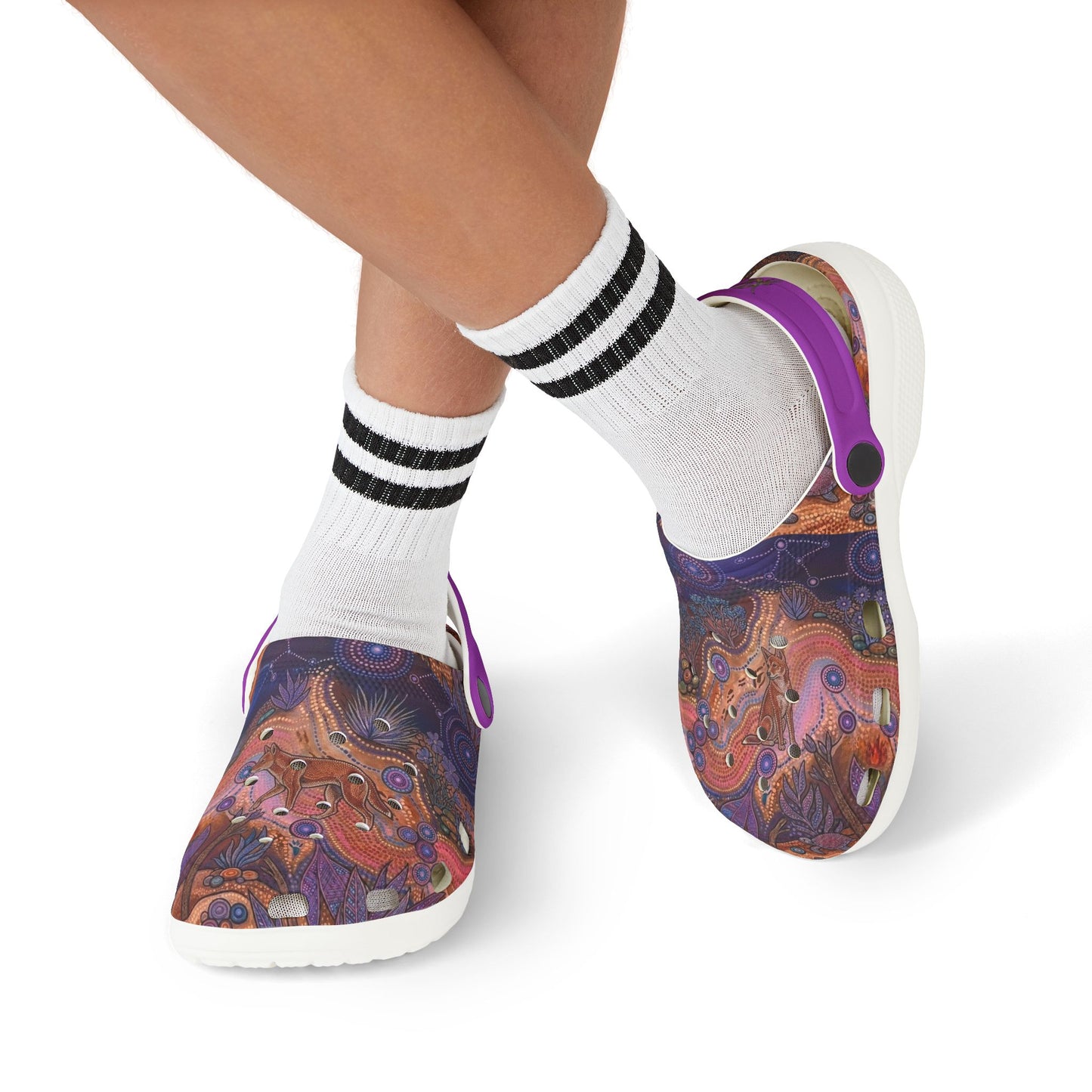 Patterned clog shoes worn with white socks and black-and-white striped cuffs