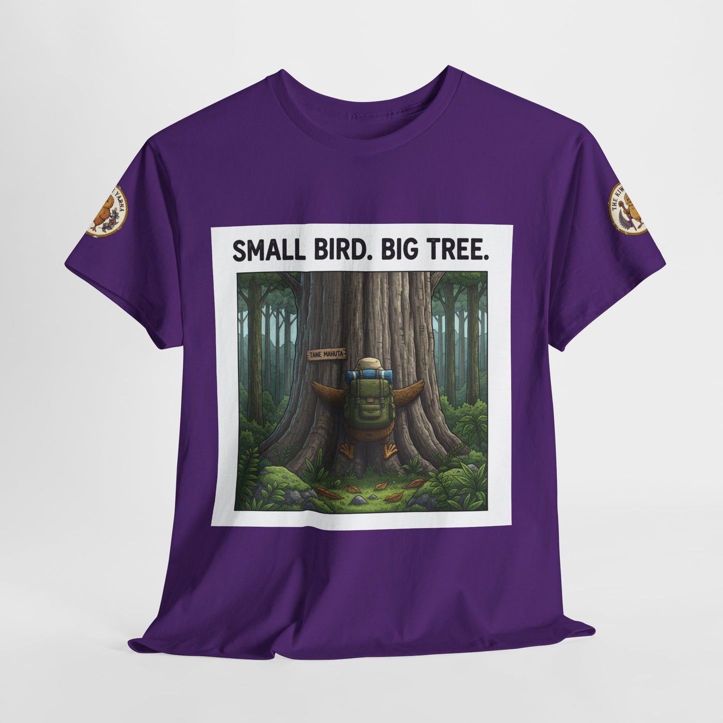 Purple graphic t-shirt front with tree scene and 'Small Bird. Big Tree.' text