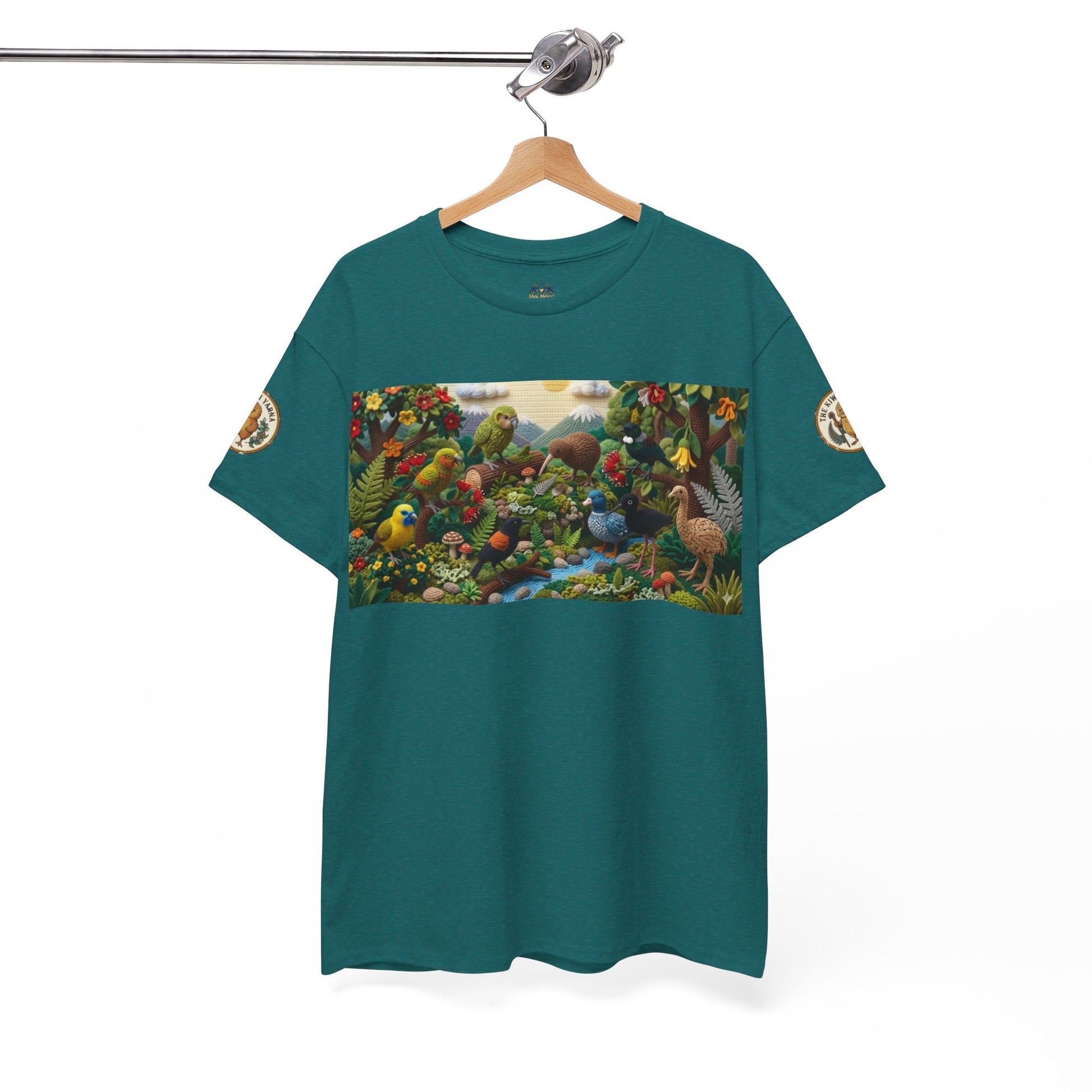 Teal T-shirt hanging on a wooden hanger with rectangular bird scene front graphic.