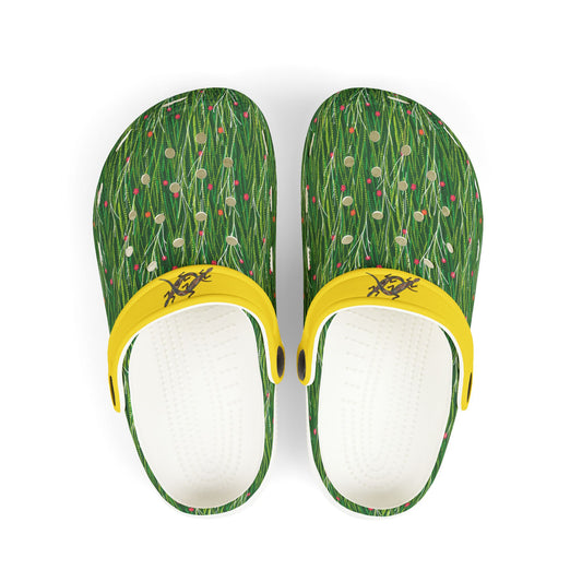 Pair of green patterned clogs with yellow strap and white footbed