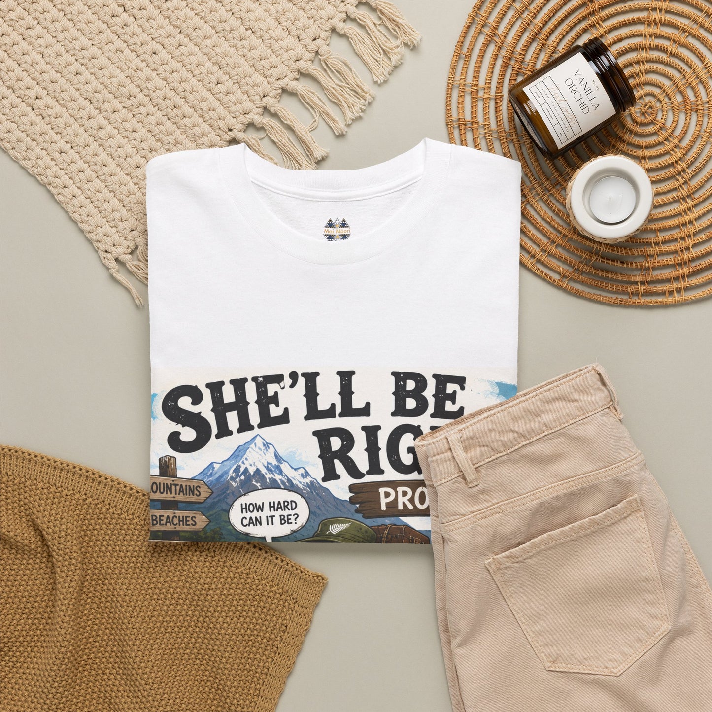 White graphic T-shirt with large front slogan and truck scene print, laid flat with accessories.