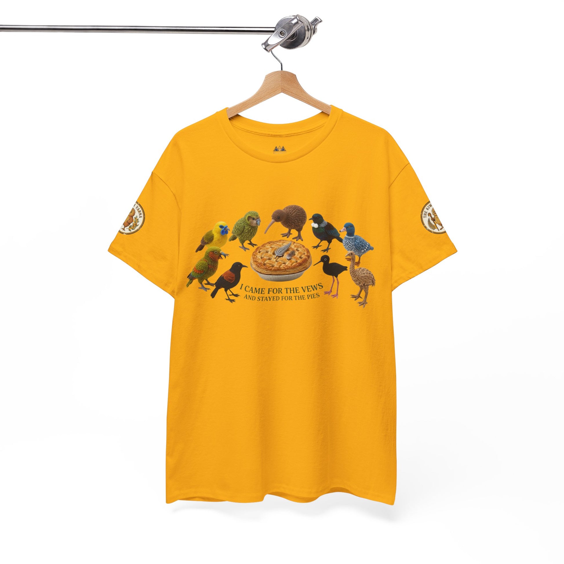 Yellow graphic T-shirt hanging on a white hanger, birds and pizza print