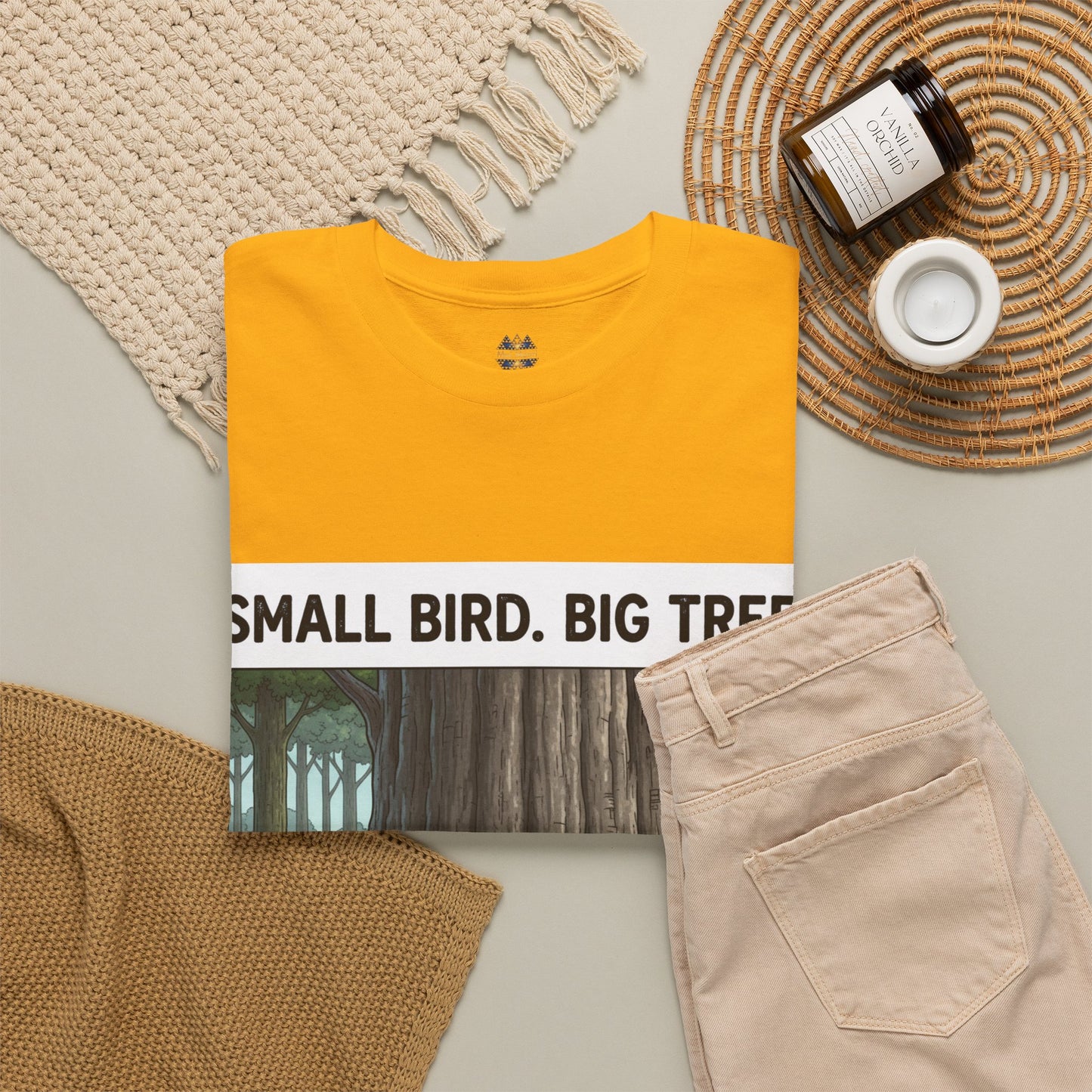 Mustard yellow graphic T-shirt with 'SMALL BIRD. BIG TR' print panel, crew neck