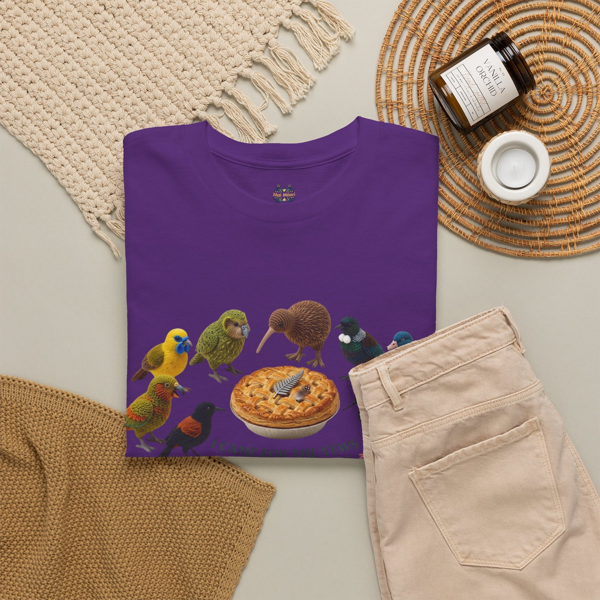 Purple graphic T-shirt with birds and pie-style emblem, folded