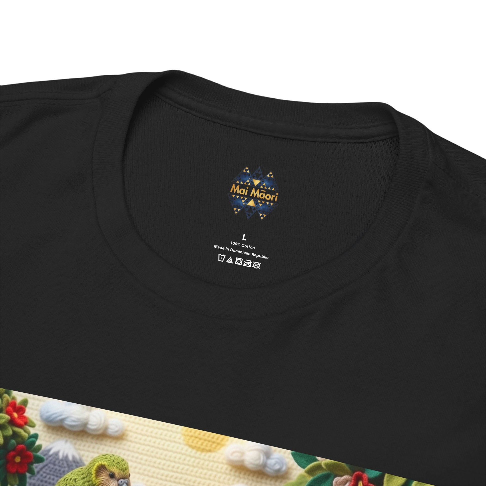Black T-shirt close-up of chest logo and bird-scene print on front hem