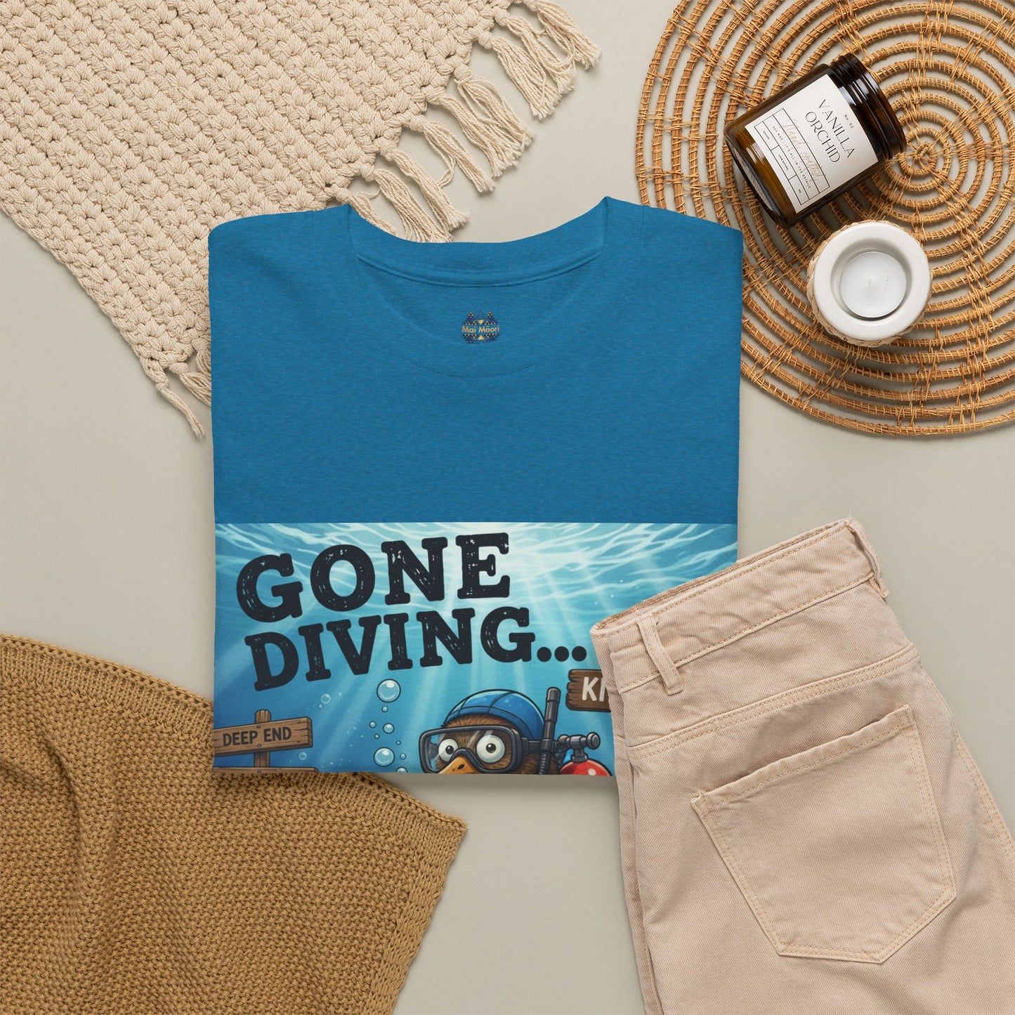 Teal T-shirt folded with scuba diver graphic panel on front