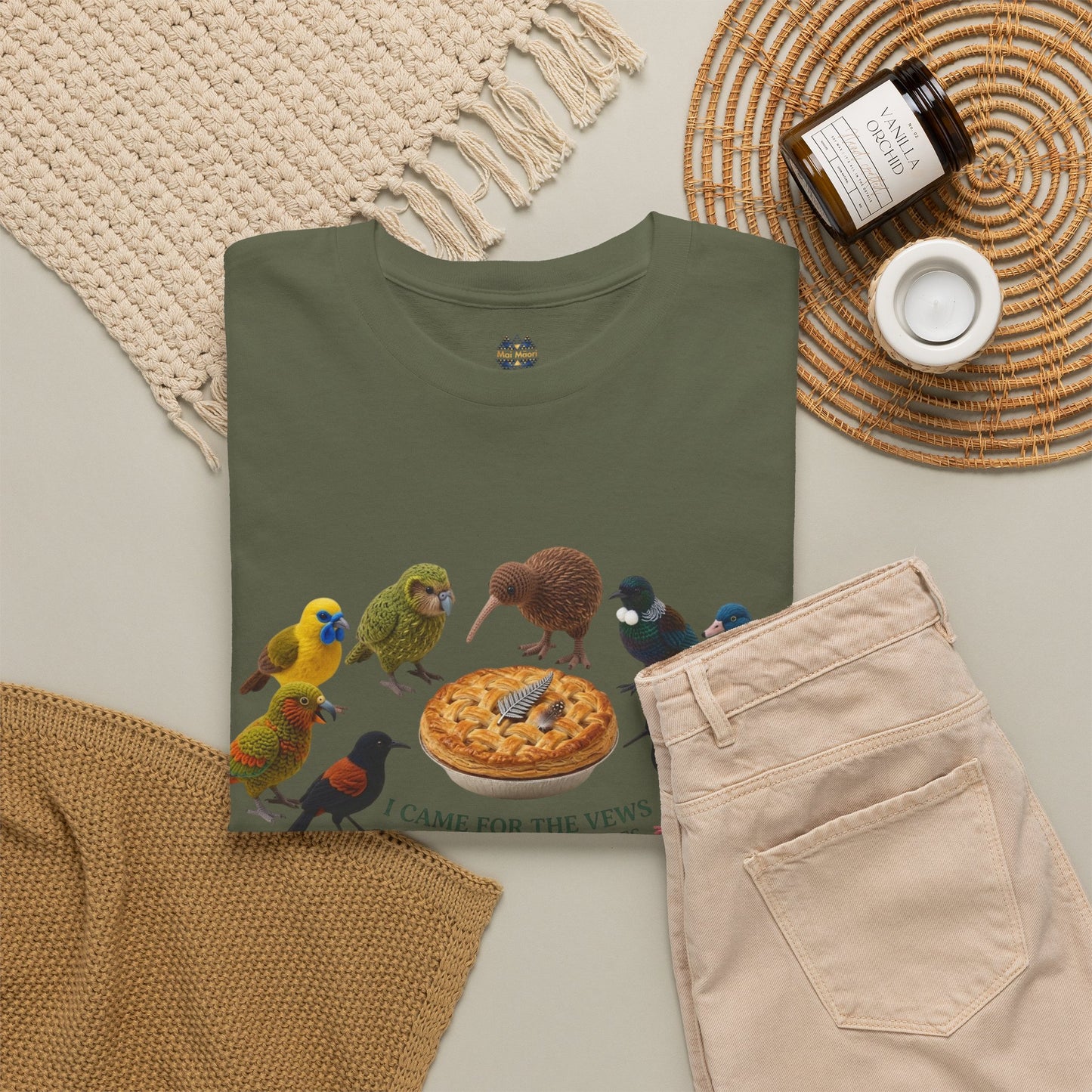 Olive green T-shirt with birds and pizza graphic, folded flat