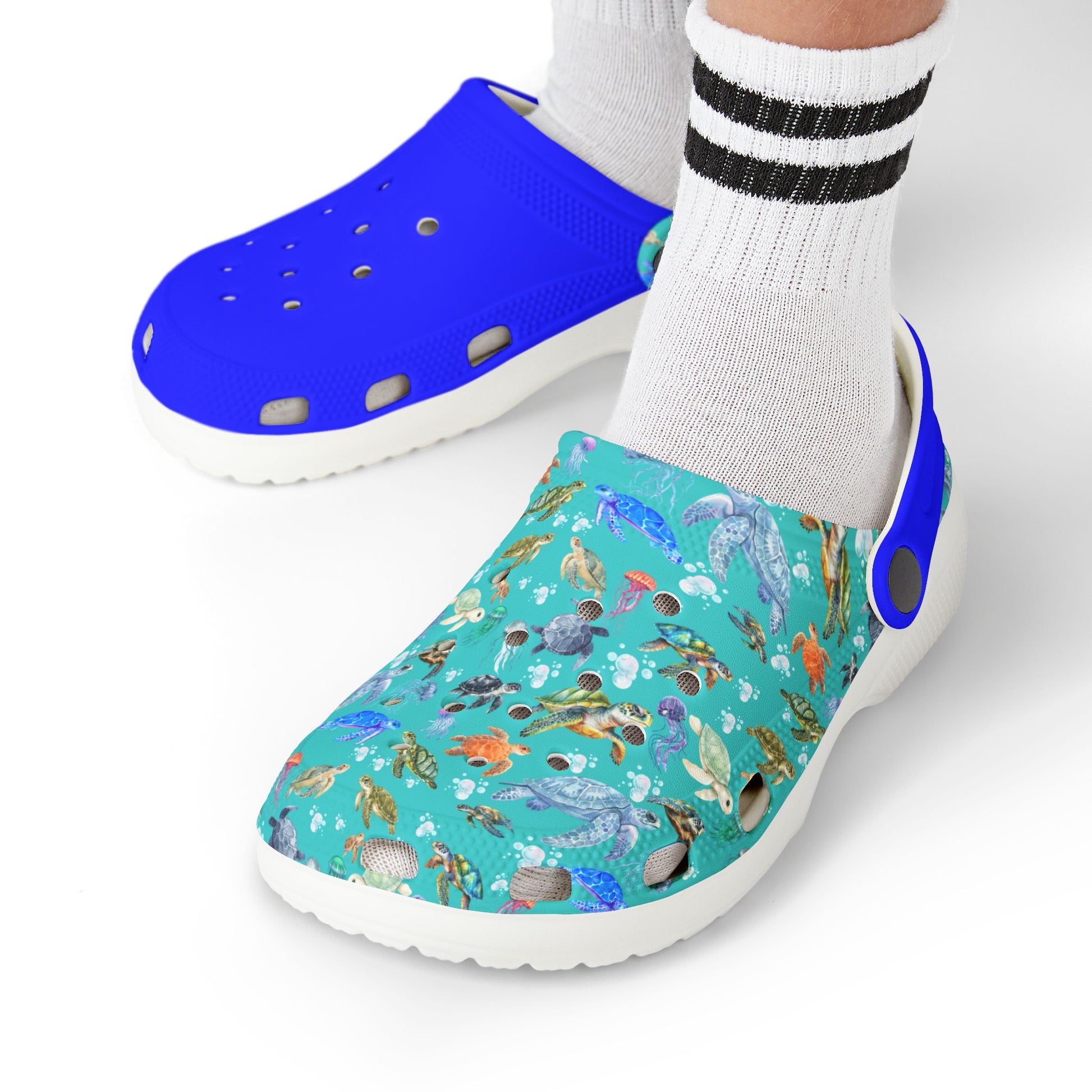 Kids slip-on clogs with blue upper, teal ocean-pattern side, and white platform sole