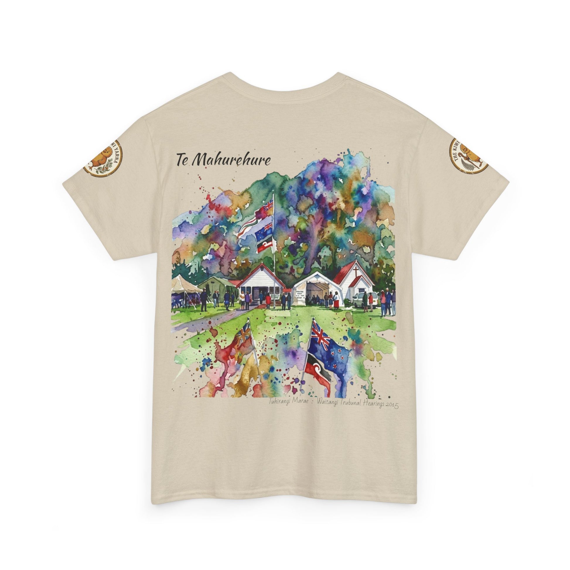 Beige crew-neck T-shirt with colorful watercolor-style village scene graphic on front.