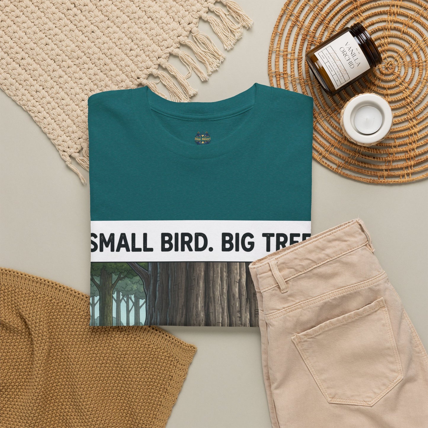 Teal crew-neck T-shirt with small chest logo and partial white-framed forest print