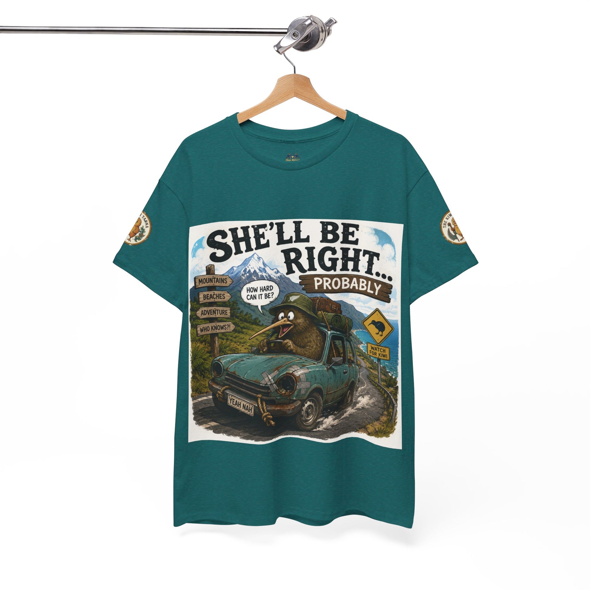 Teal graphic T-shirt hanging on a hanger, front car scene artwork and sleeve patches.