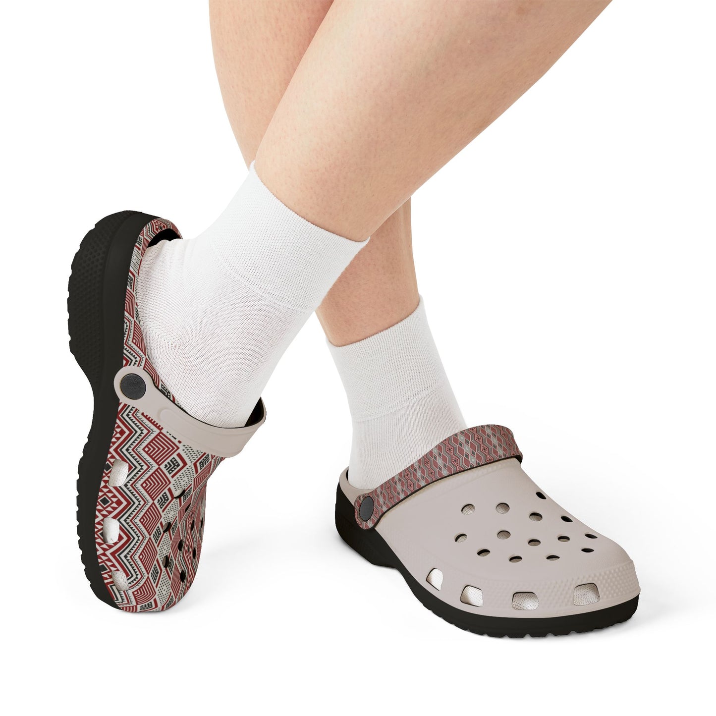 Slide clogs on feet with white perforated toe and red-and-white patterned upper; white socks.