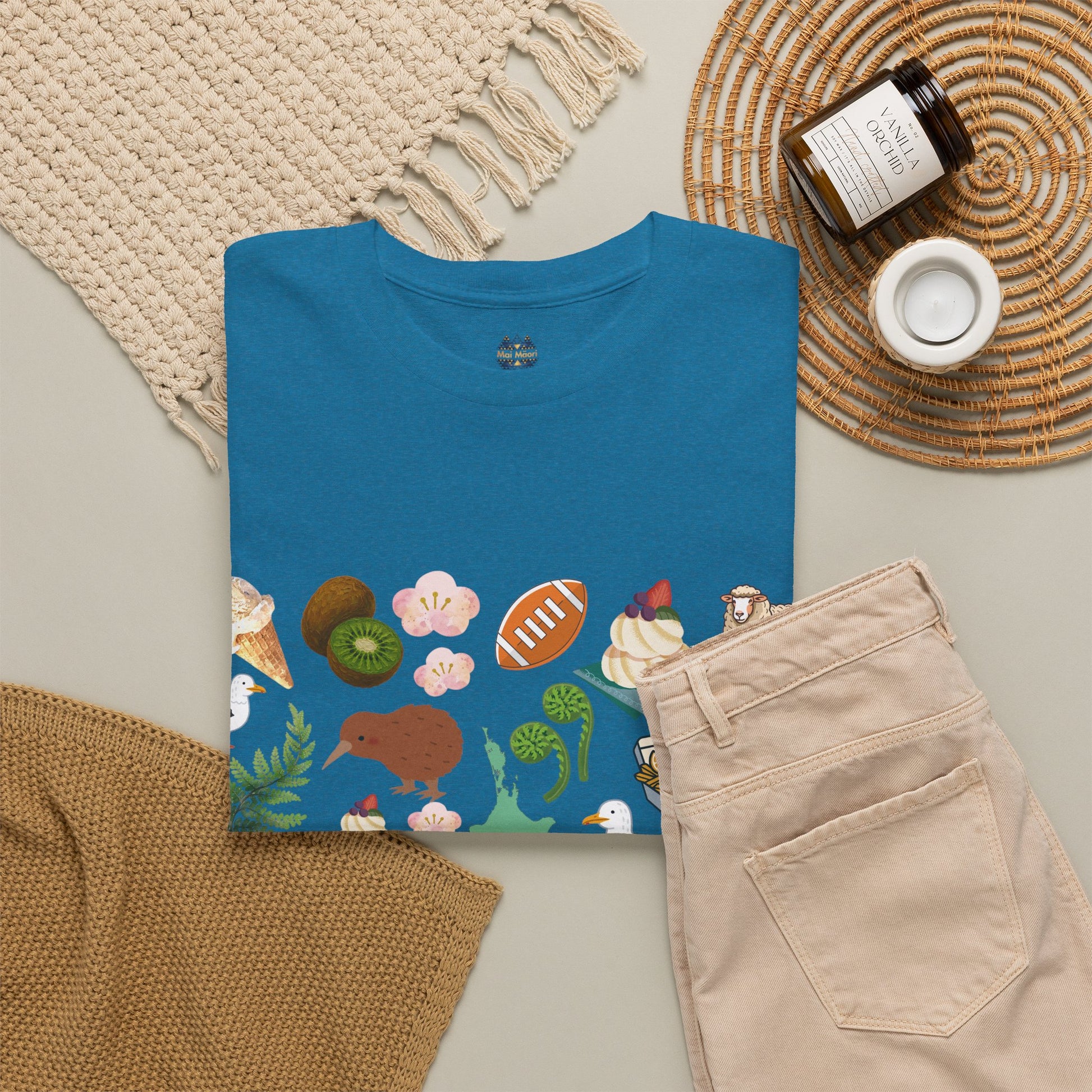 Blue graphic T-shirt with colorful wildlife and plant print on the chest