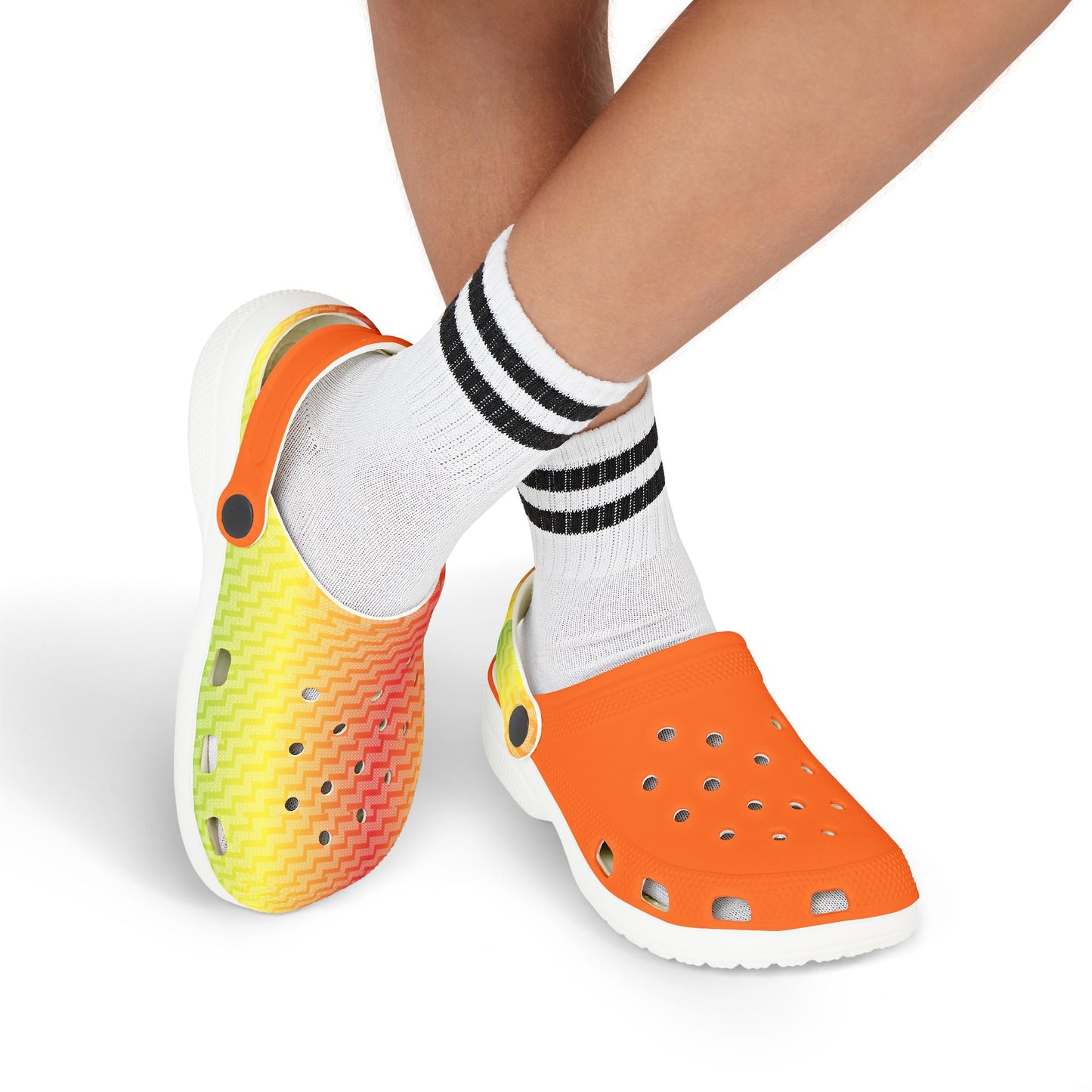 Croc-style clogs being worn: orange perforated clog with multicolor-patterned heel