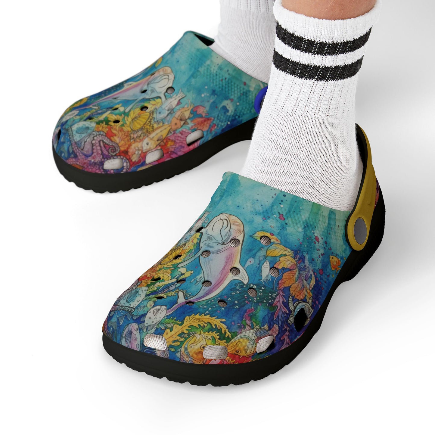 Kids ocean-print clog shoes on feet with white socks; black sole and yellow strap
