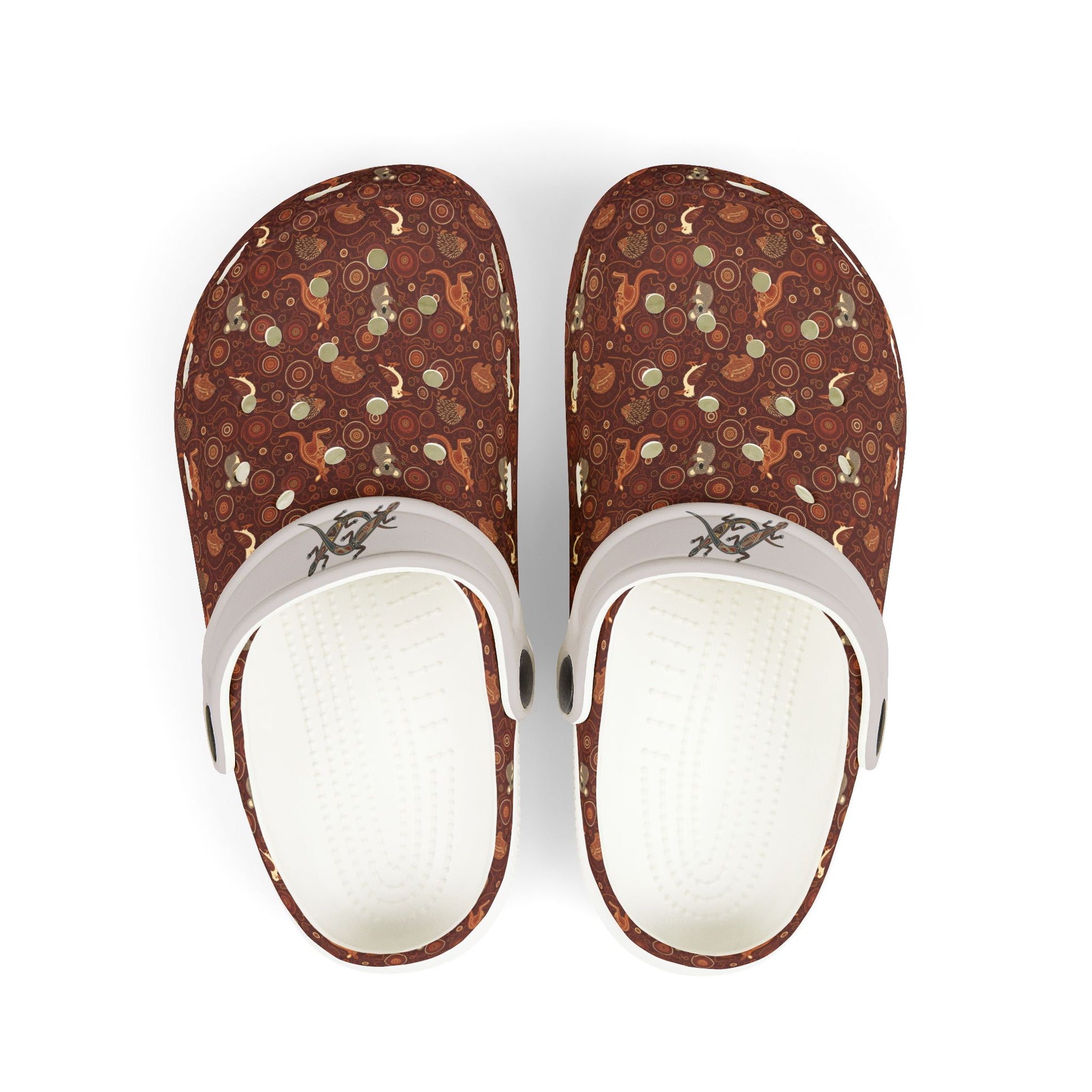 Printed casual clog shoes with white straps and open vents on maroon-brown fabric.