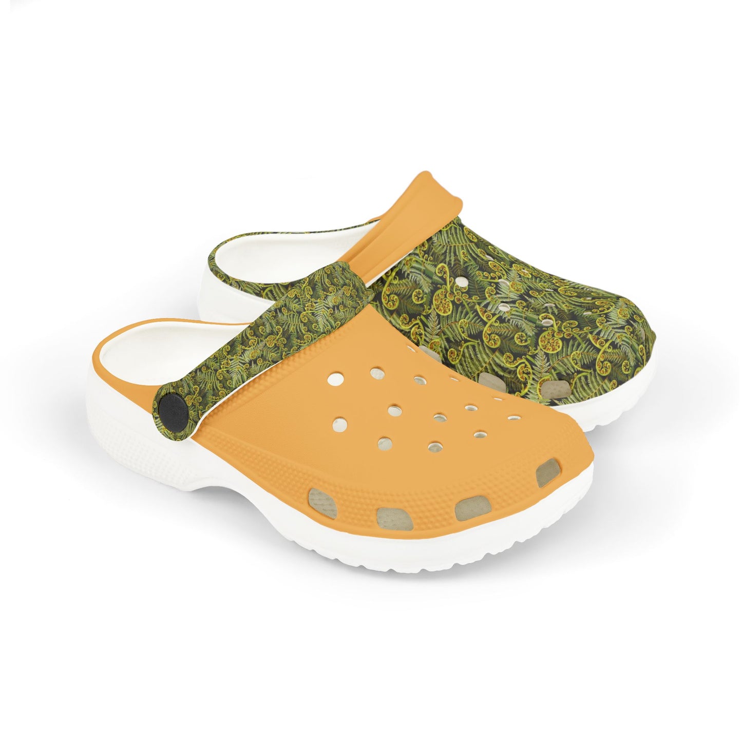 Slip-on clogs with green patterned upper, tan forefoot, and white cushioned sole