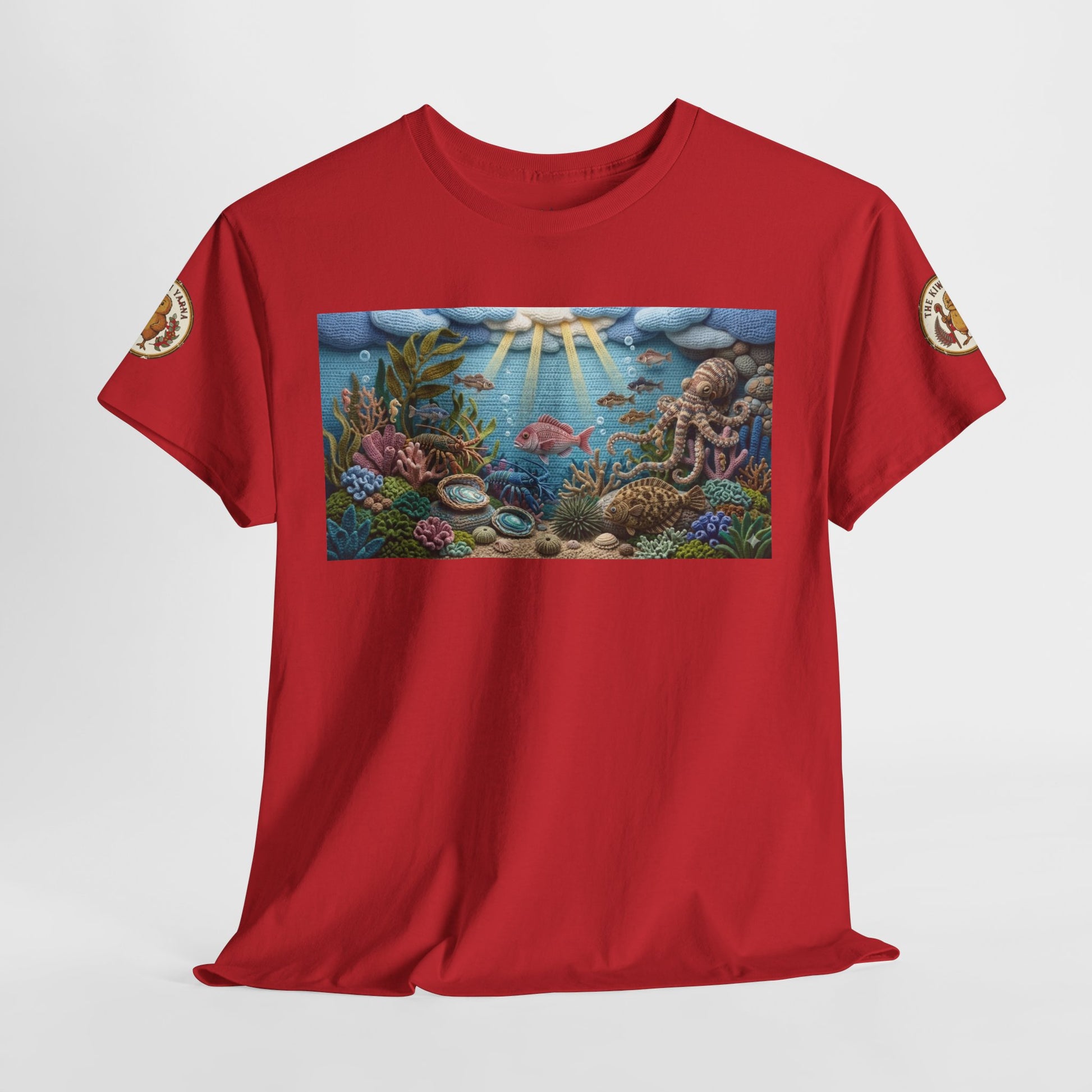 Red T-shirt laid flat with rectangular underwater sea-life print and round sleeve emblem.