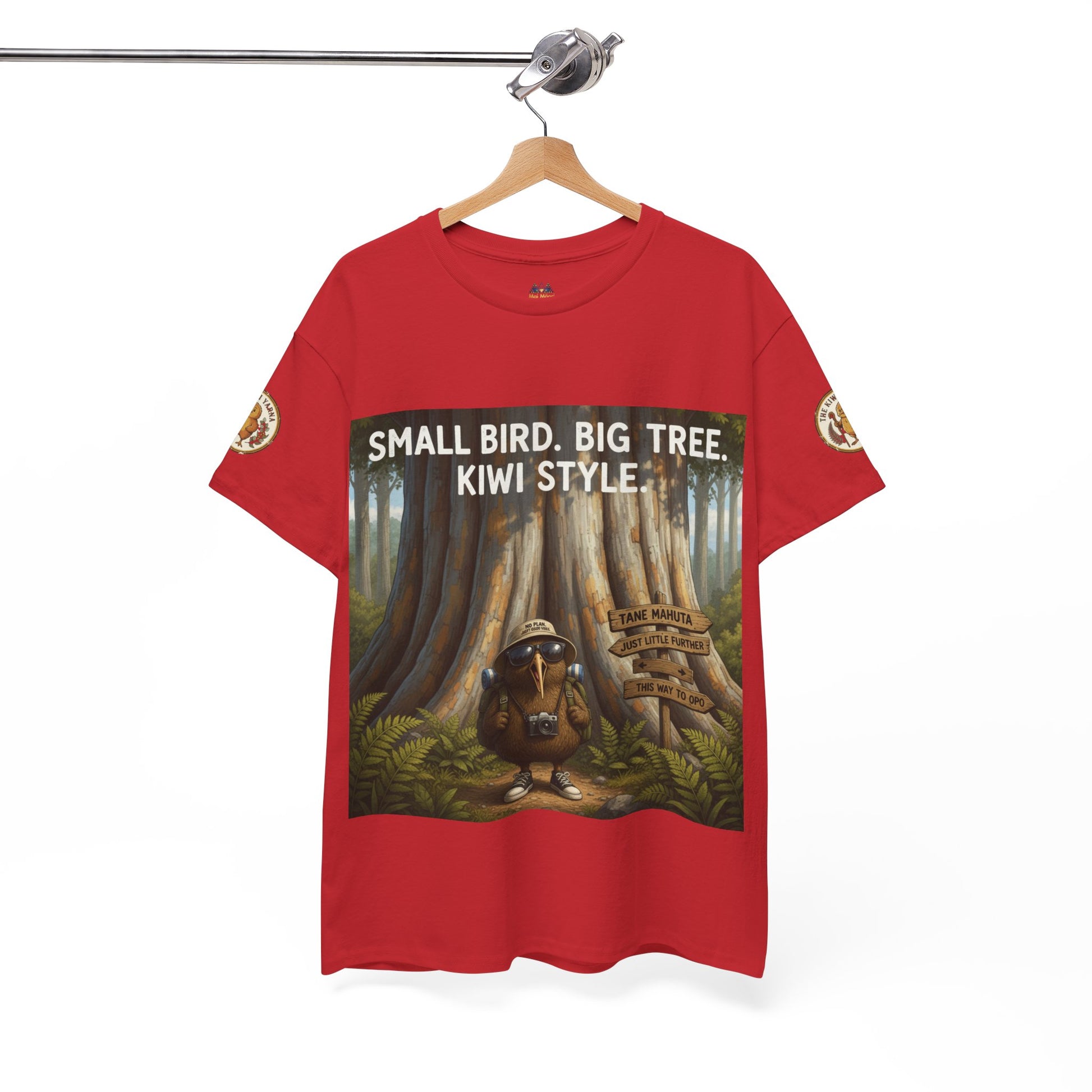 Red graphic t-shirt front view on hanger with framed tree and kiwi-style artwork