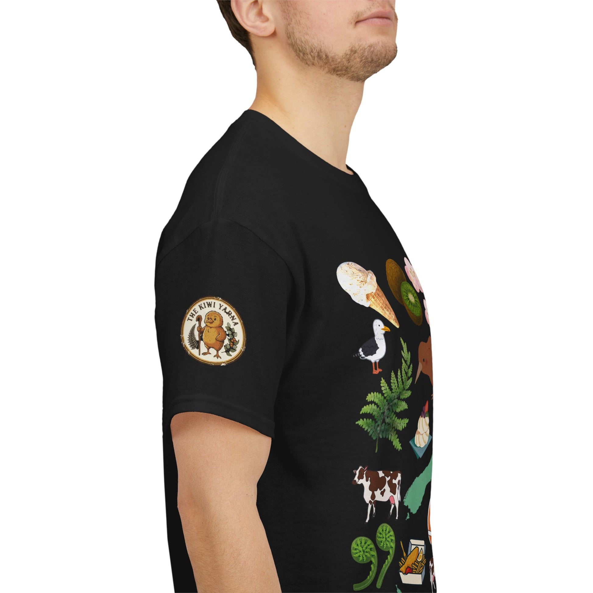 Kiwiana-inspired T-shirt, black with circular emblem on sleeve and wildlife/fern graphic