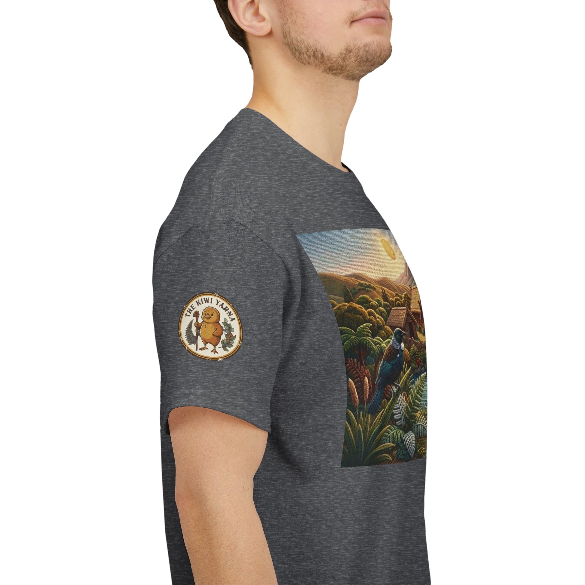 Dark gray crew-neck T-shirt on model, side view with sleeve patch logo and scenic print.