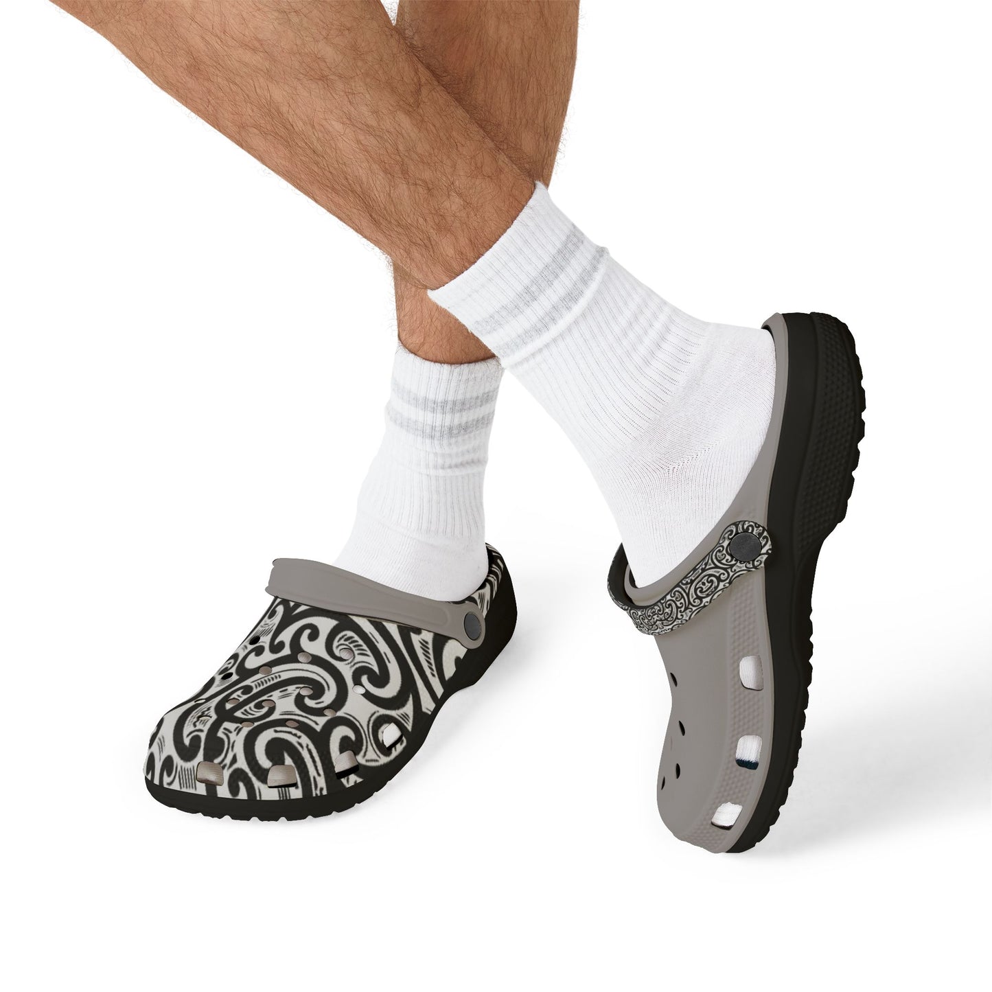 Croc-style clog on foot with black-and-white patterned top strap and light gray sole