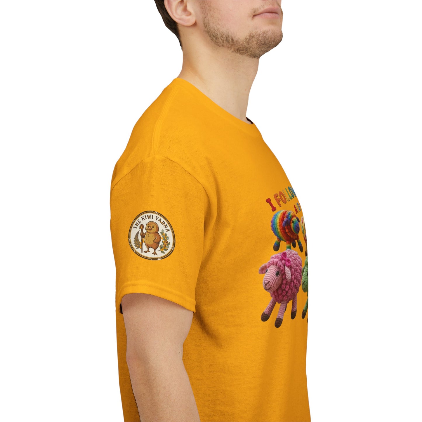Mustard yellow T-shirt with sheep graphic on sleeve and round chest logo patch.