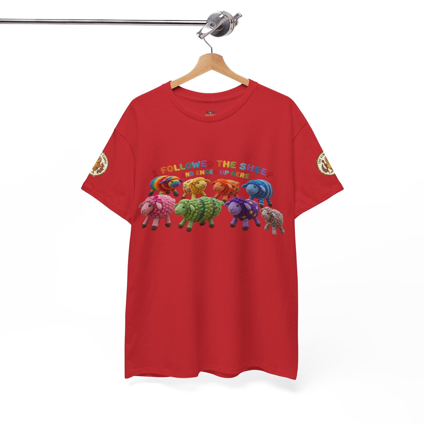 Red graphic crewneck t-shirt on hanger, with sheep illustration and multicolor text across chest.