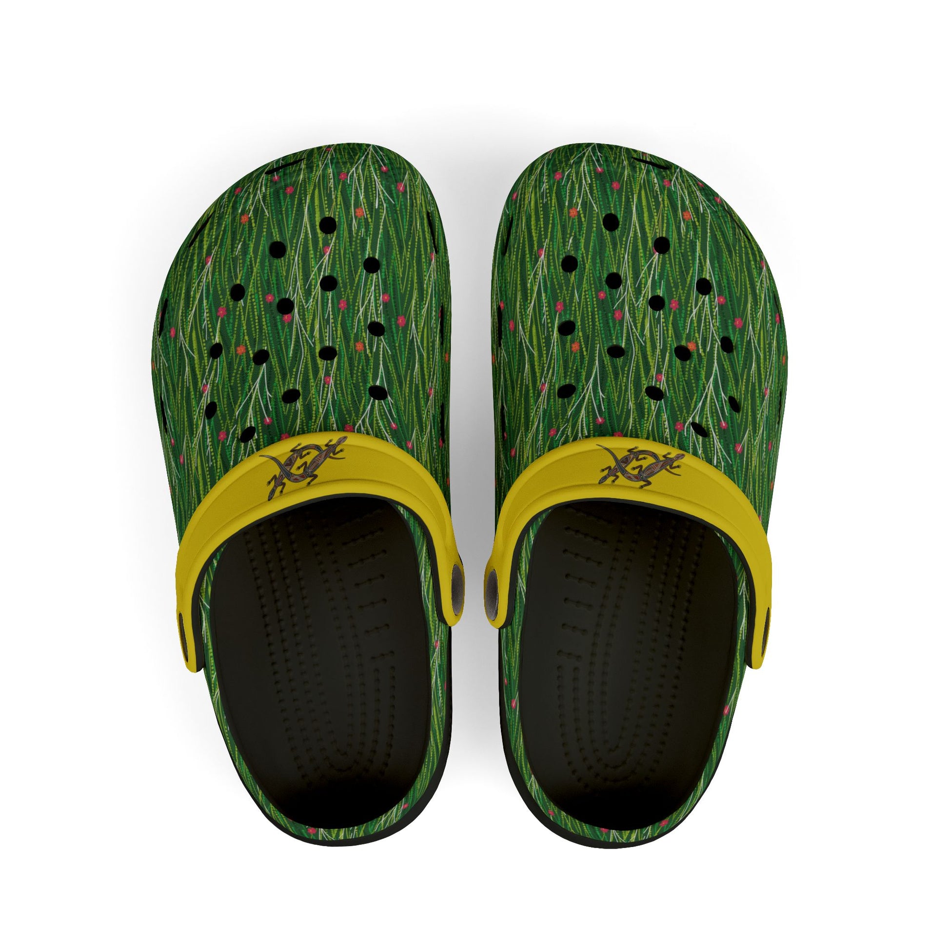 Pair of green patterned clogs with yellow strap and black interior holes