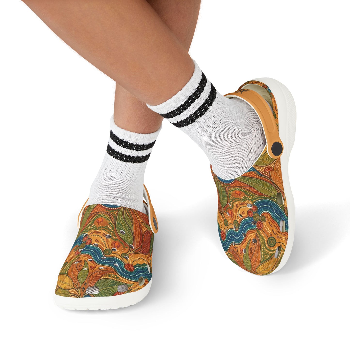 Casual slip-on clogs with colorful Aboriginal art uppers worn with white-and-black socks.