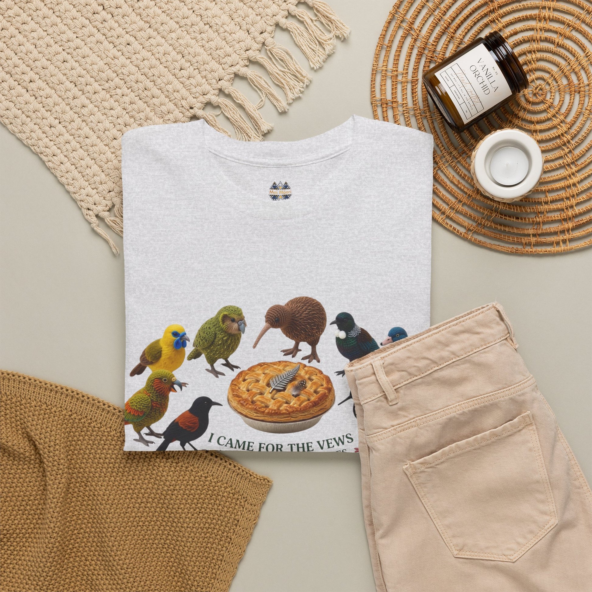 Light T-shirt with bird-and-pizza front print, shown folded with matching pants nearby.