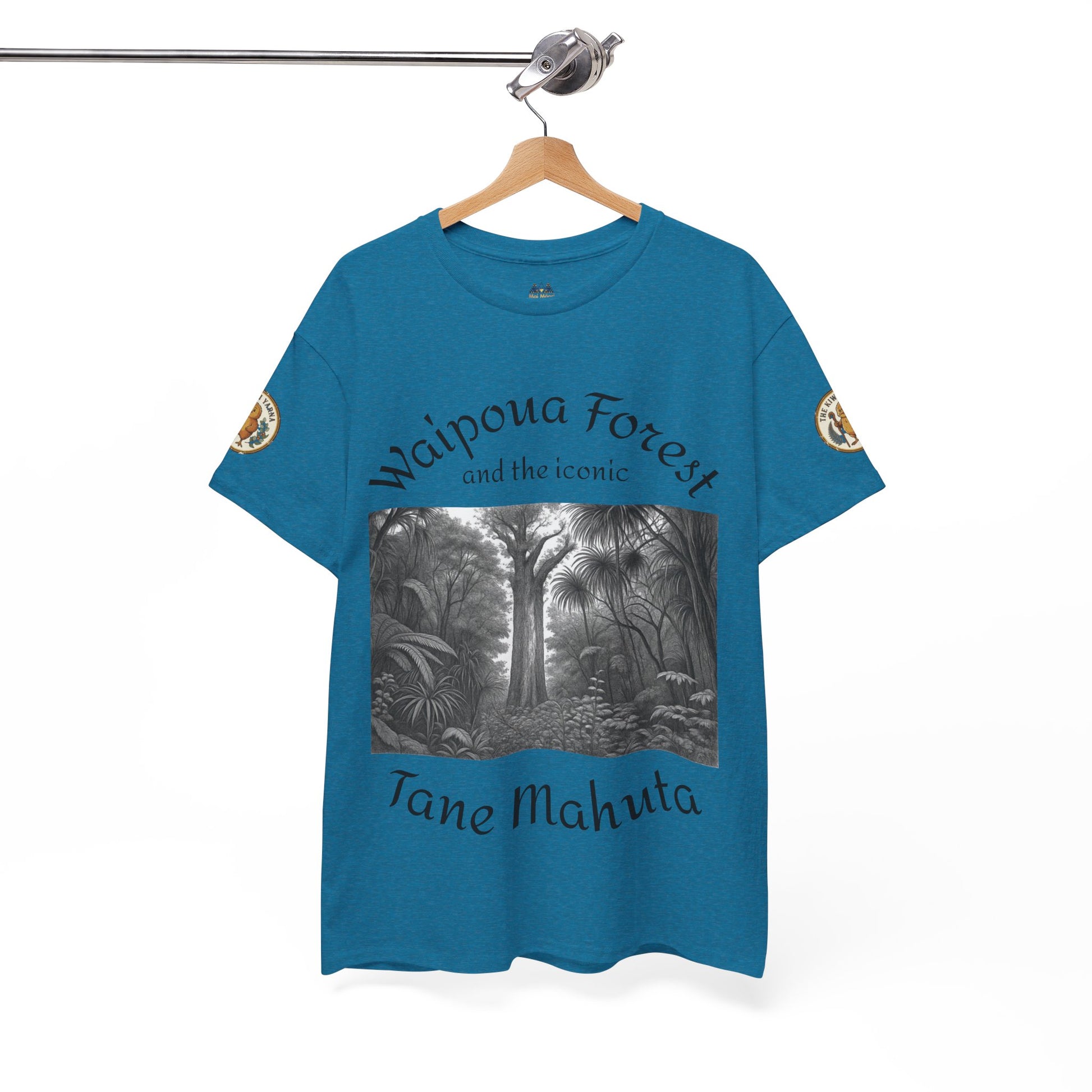 Blue graphic T-shirt on hanger with black-and-white forest print and sleeve badge details