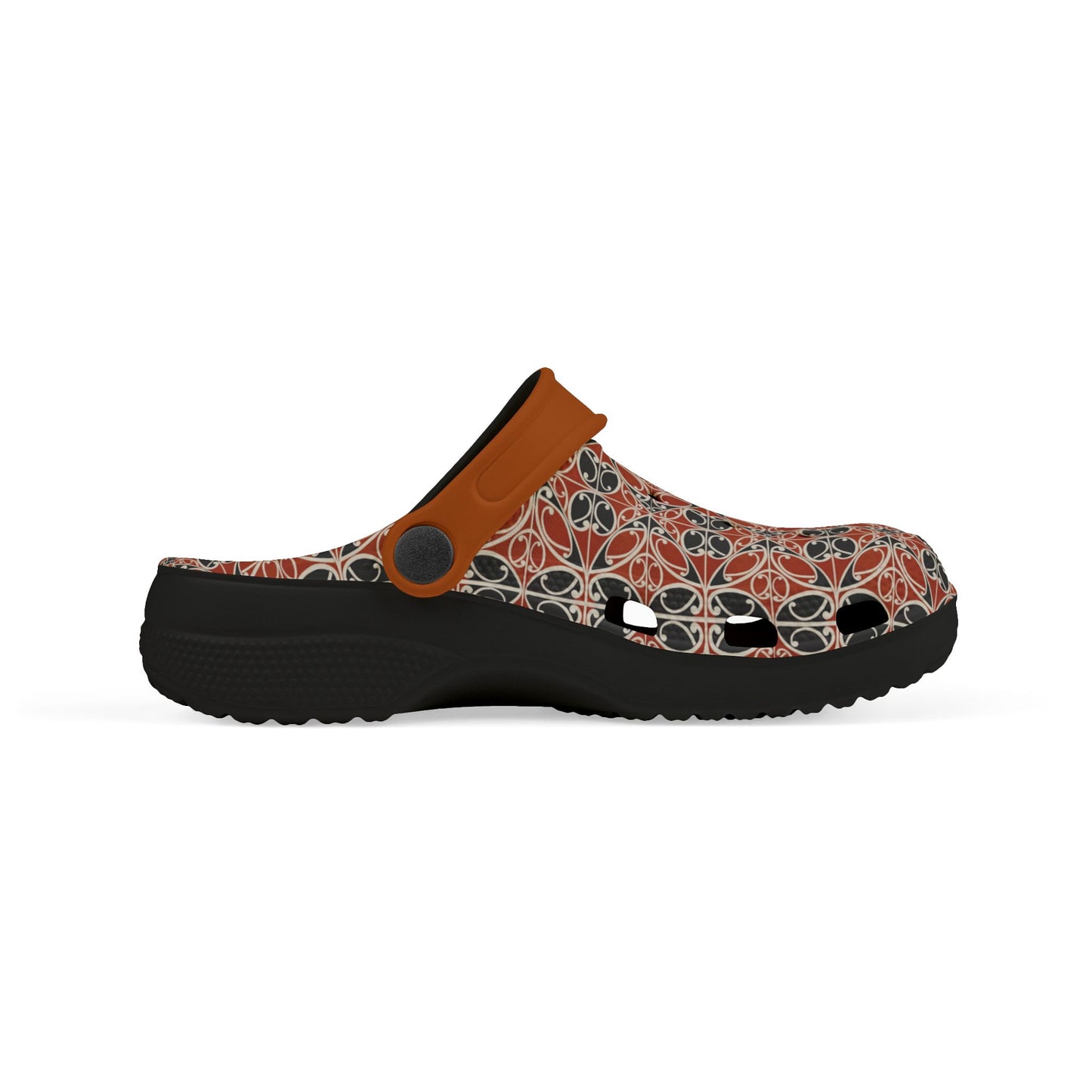 Māoritanga slide clogs side view with patterned upper, tan strap, and black sole