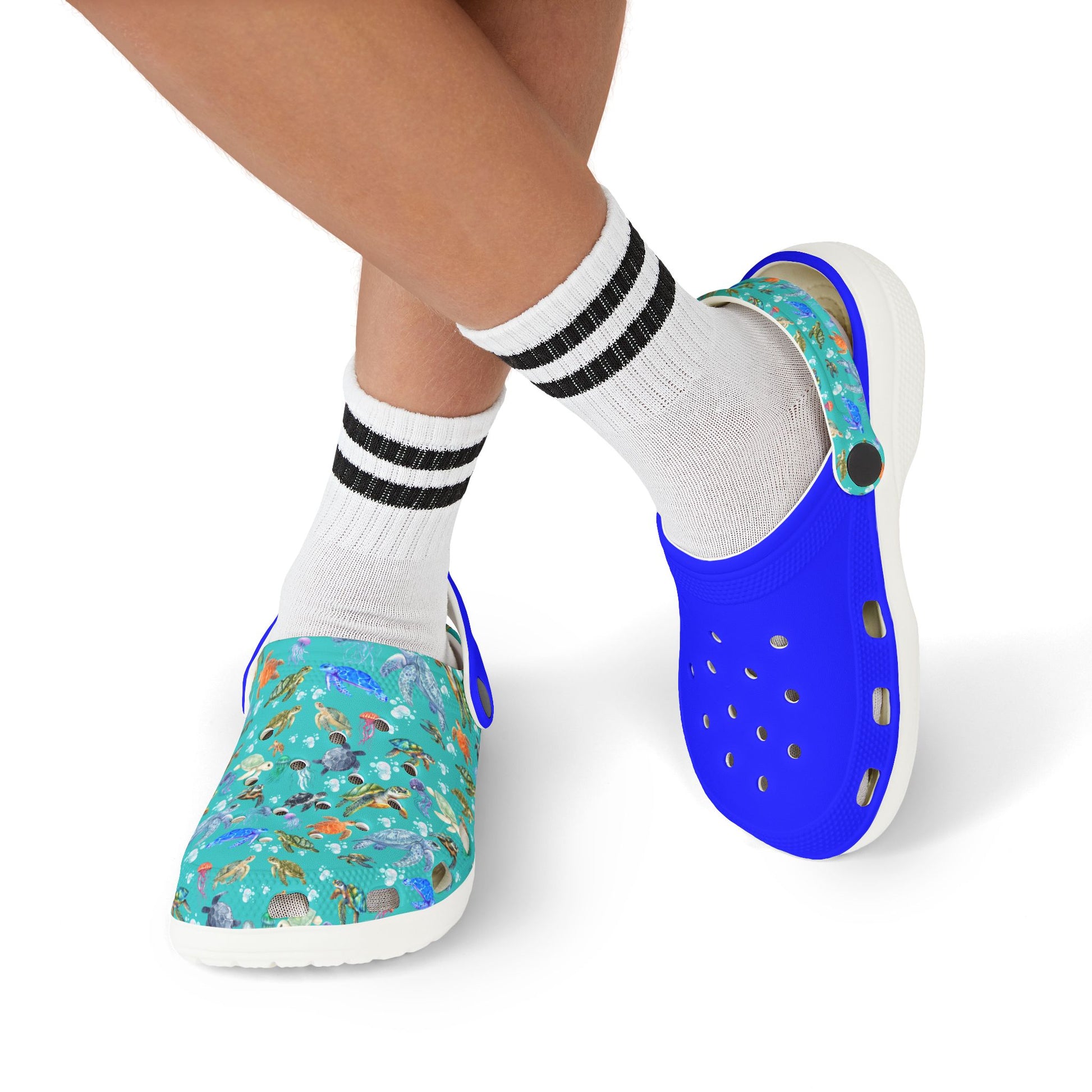 Kids slip-on clogs on feet with white socks; blue upper and teal marine-print side