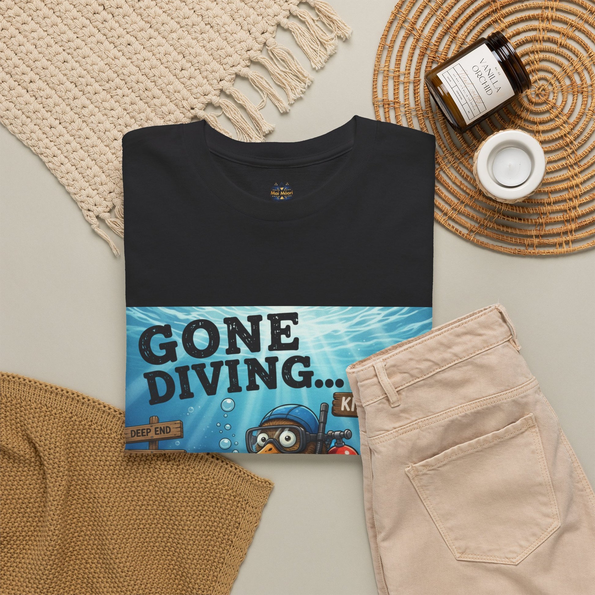 Black crewneck t-shirt with diving character print and gold sleeve patch
