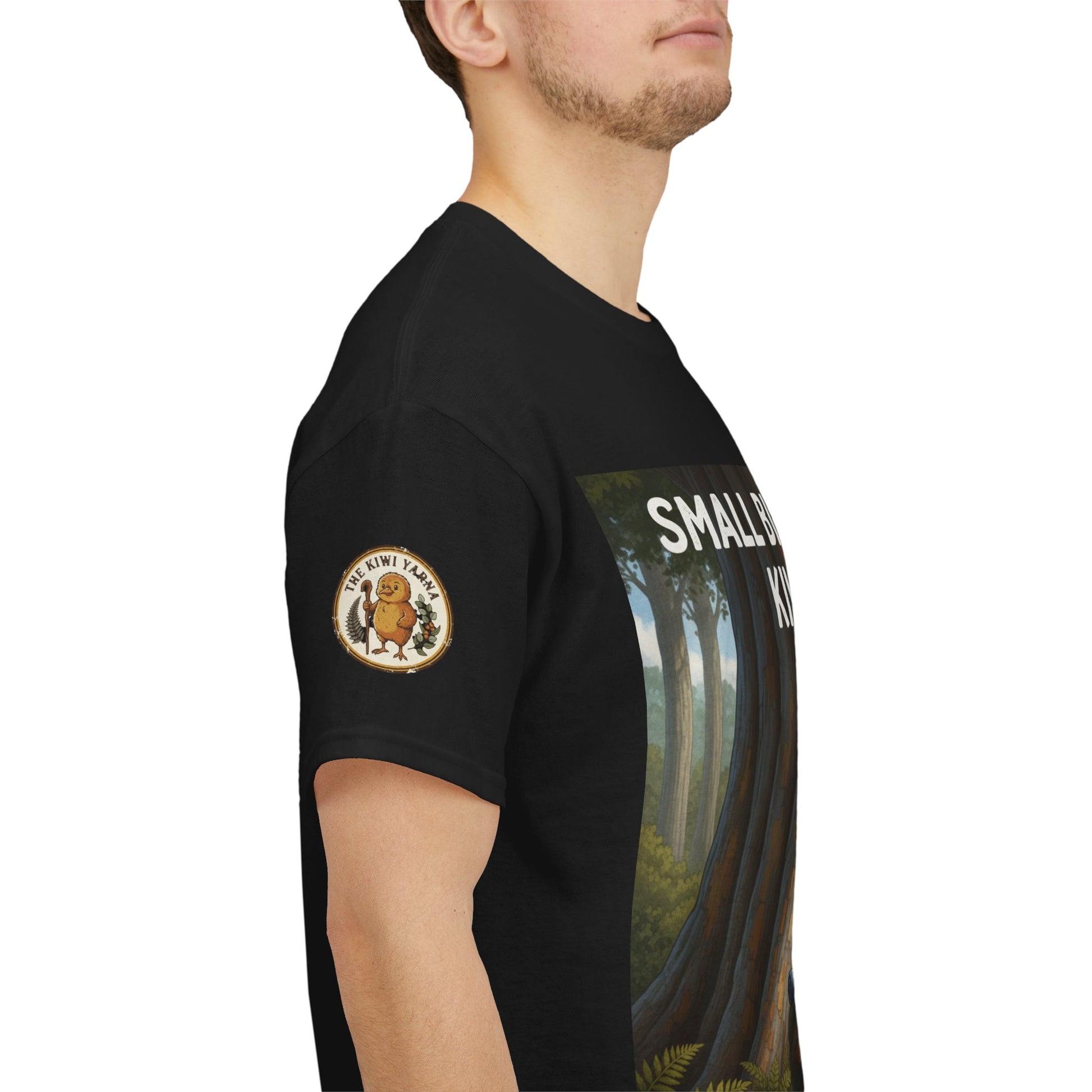 Black T-shirt on model with circular chest logo patch and side sleeve forest scene print