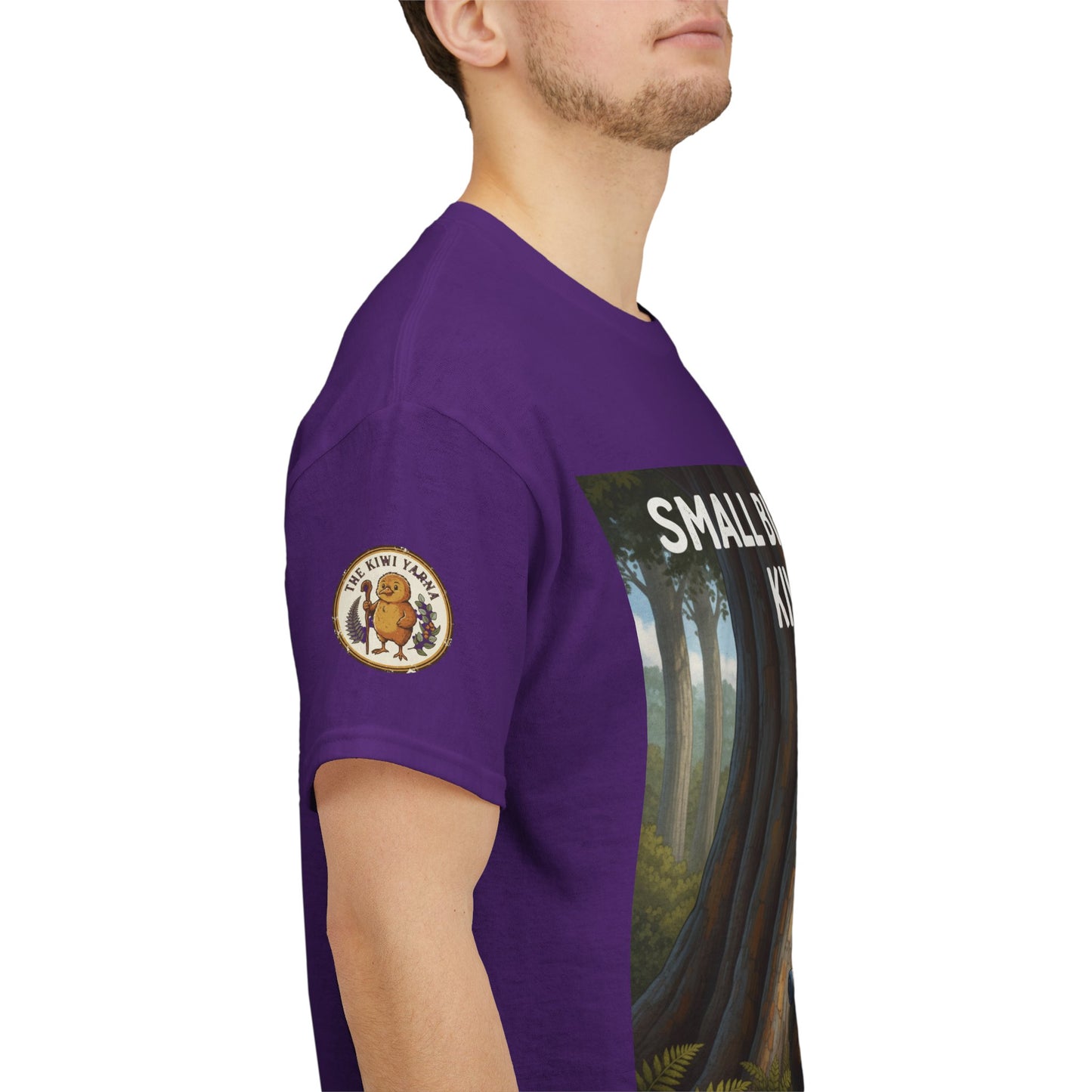 Purple t-shirt sleeve with circular logo patch and partial front graphic visible