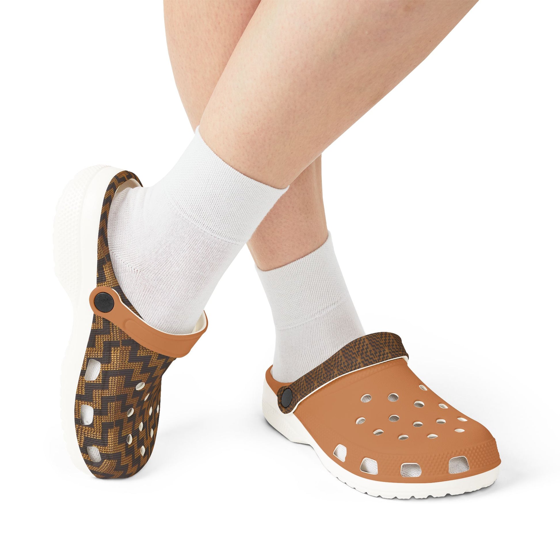 Model wearing slip-on clogs with white socks; tan perforated clog and dark patterned clog
