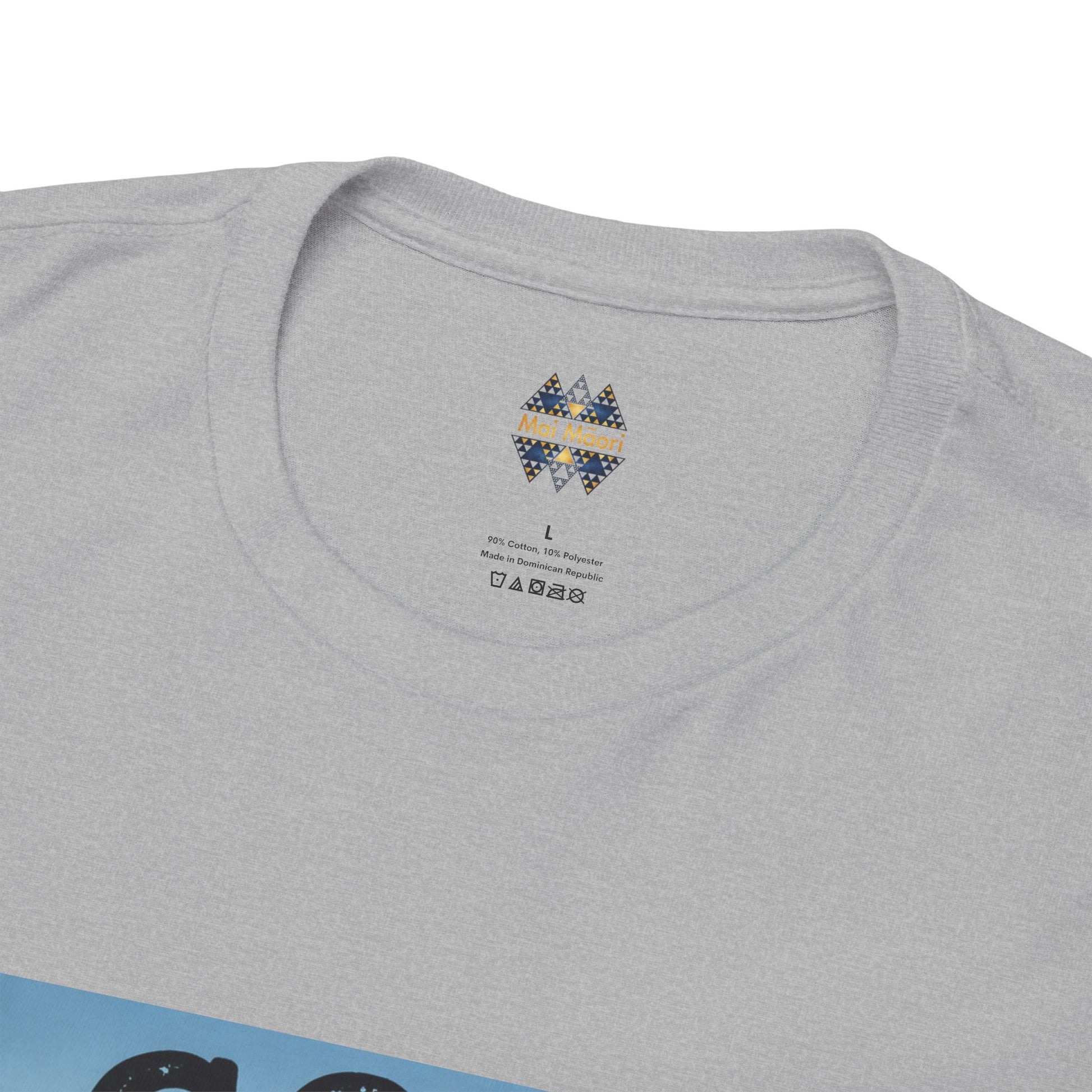 Grey T-shirt close-up: small back neckline emblem above the shirt collar