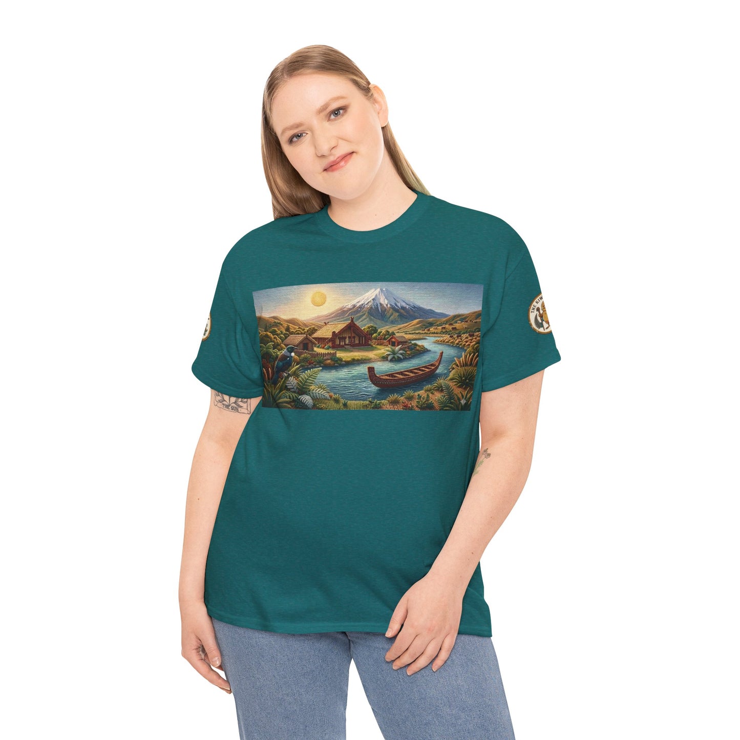 Teal crewneck T-shirt worn by a model with front landscape graphic and canoe near a peak.