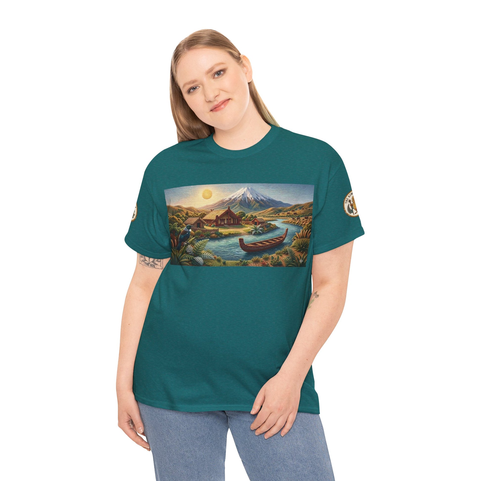 Teal crewneck T-shirt worn by a model with front landscape graphic and canoe near a peak.