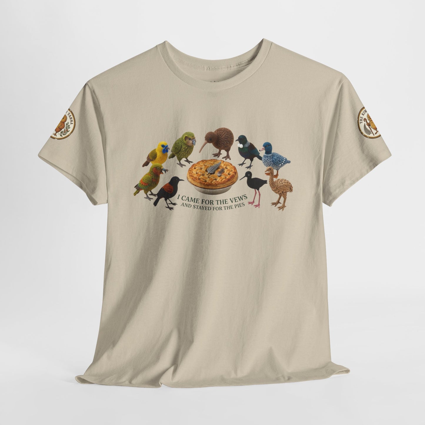 Natural crew-neck T-shirt with front birds-and-pie graphic and small sleeve patches.