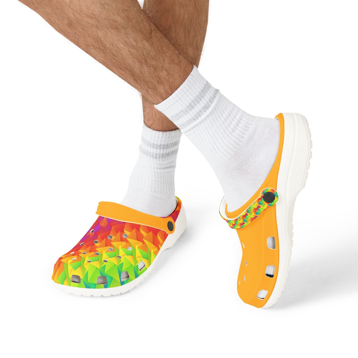 Clog shoes worn with white crew socks, featuring orange upper and geometric print