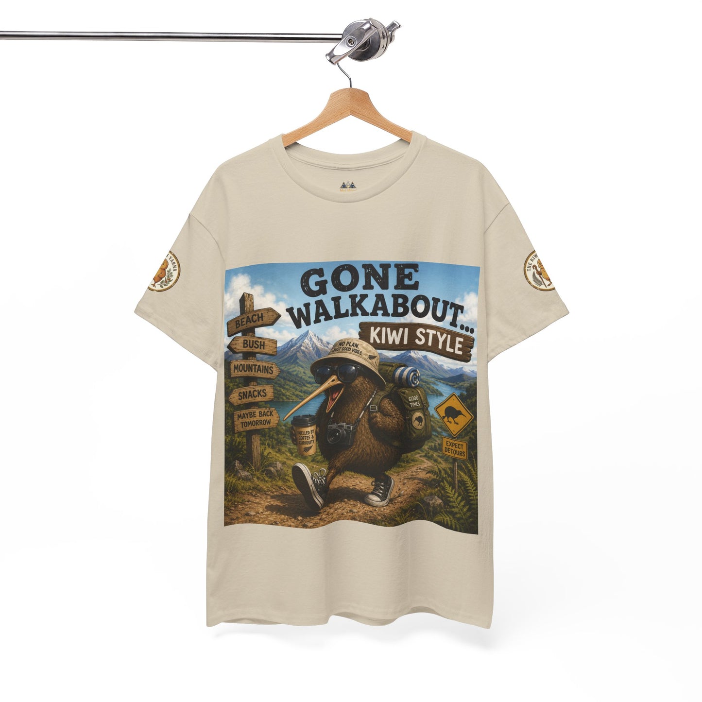Natural T-shirt on hanger with “Gone Walkabout Kiwi Style” front graphic and sleeve patches.