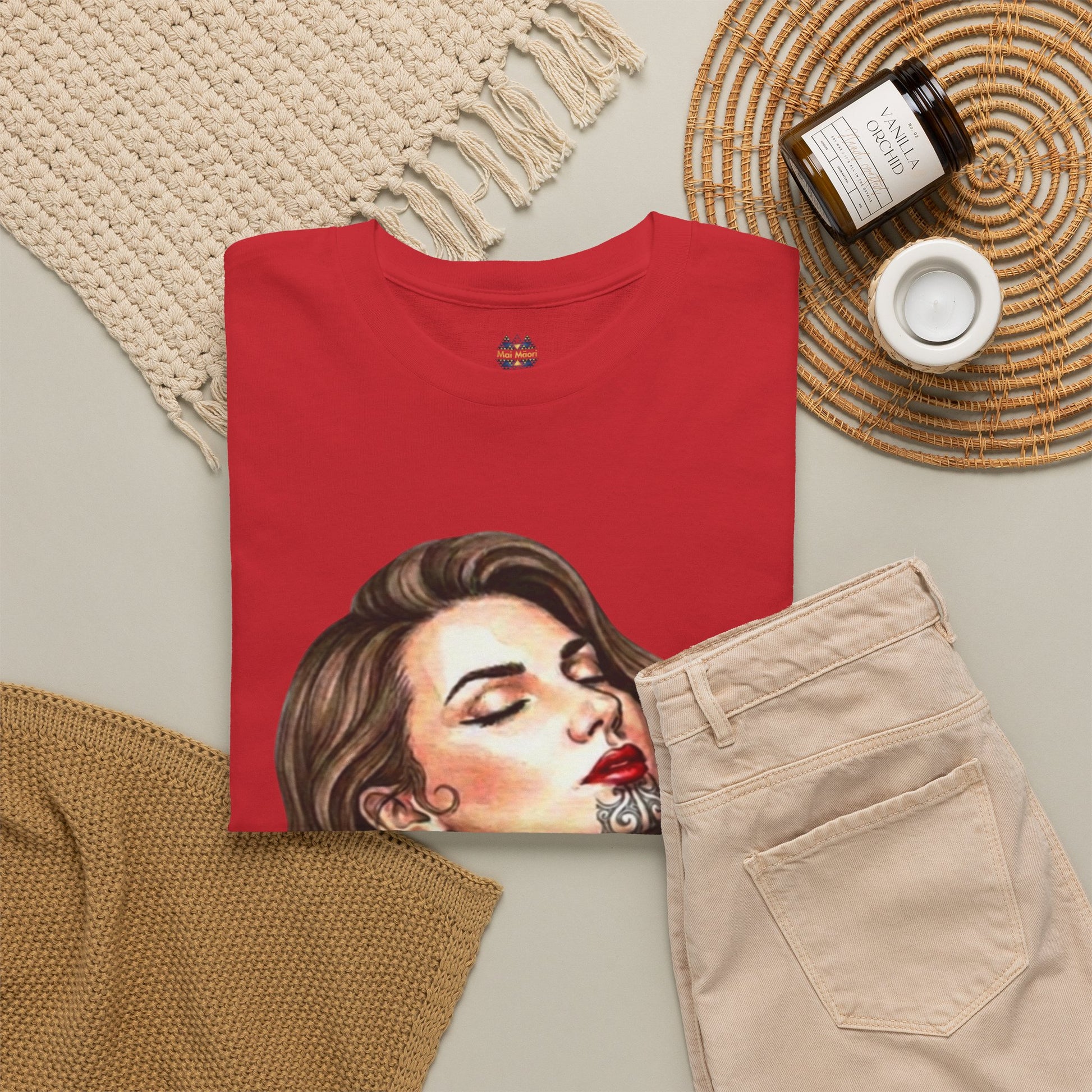 Red graphic T-shirt laid flat with crew neck and partial woman portrait artwork.