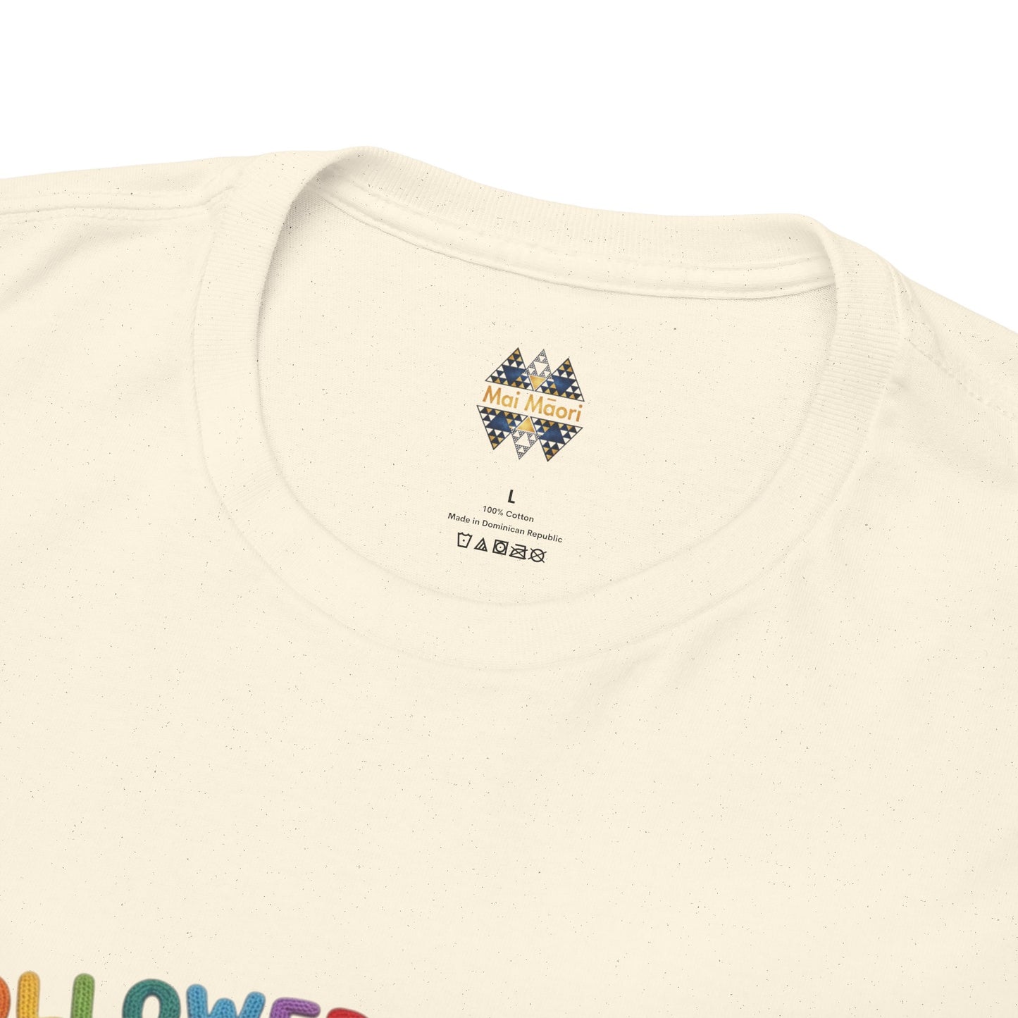 Cream T-shirt neckline close-up with small brand label at center.