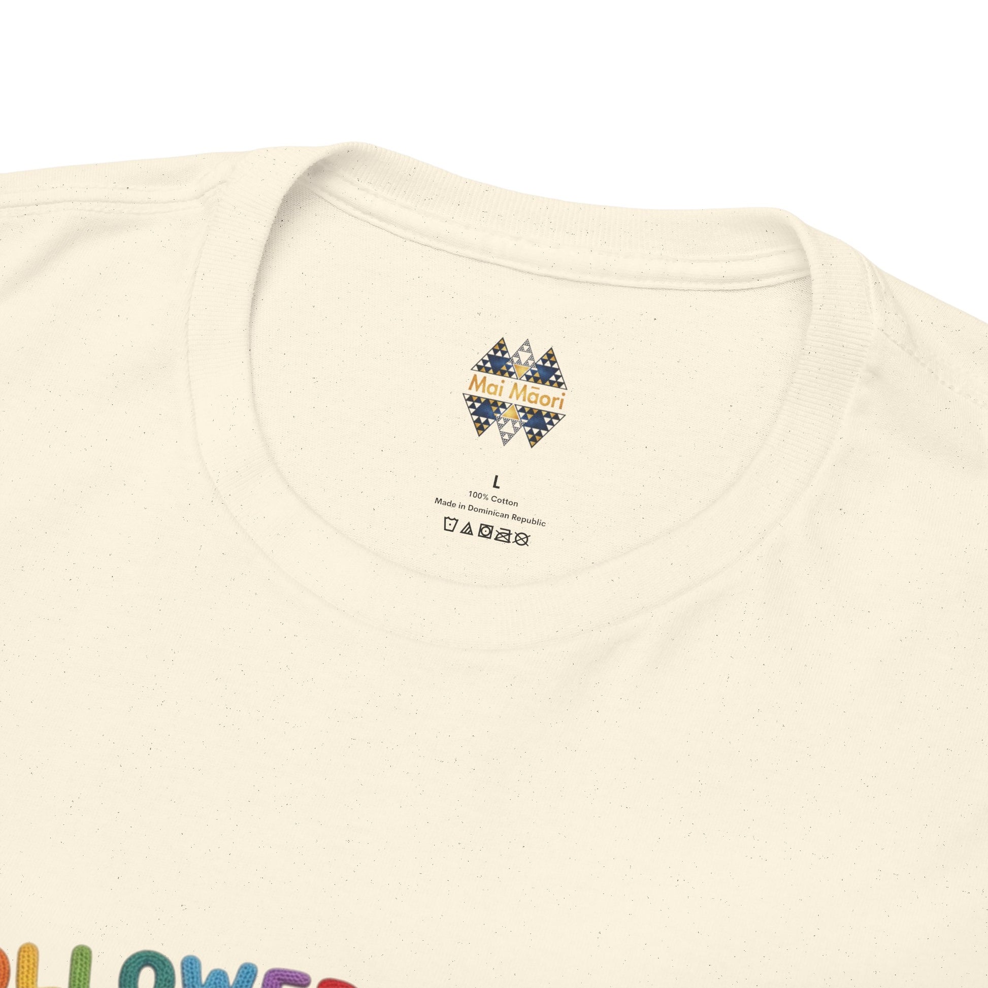 Cream T-shirt neckline close-up with small brand label at center.