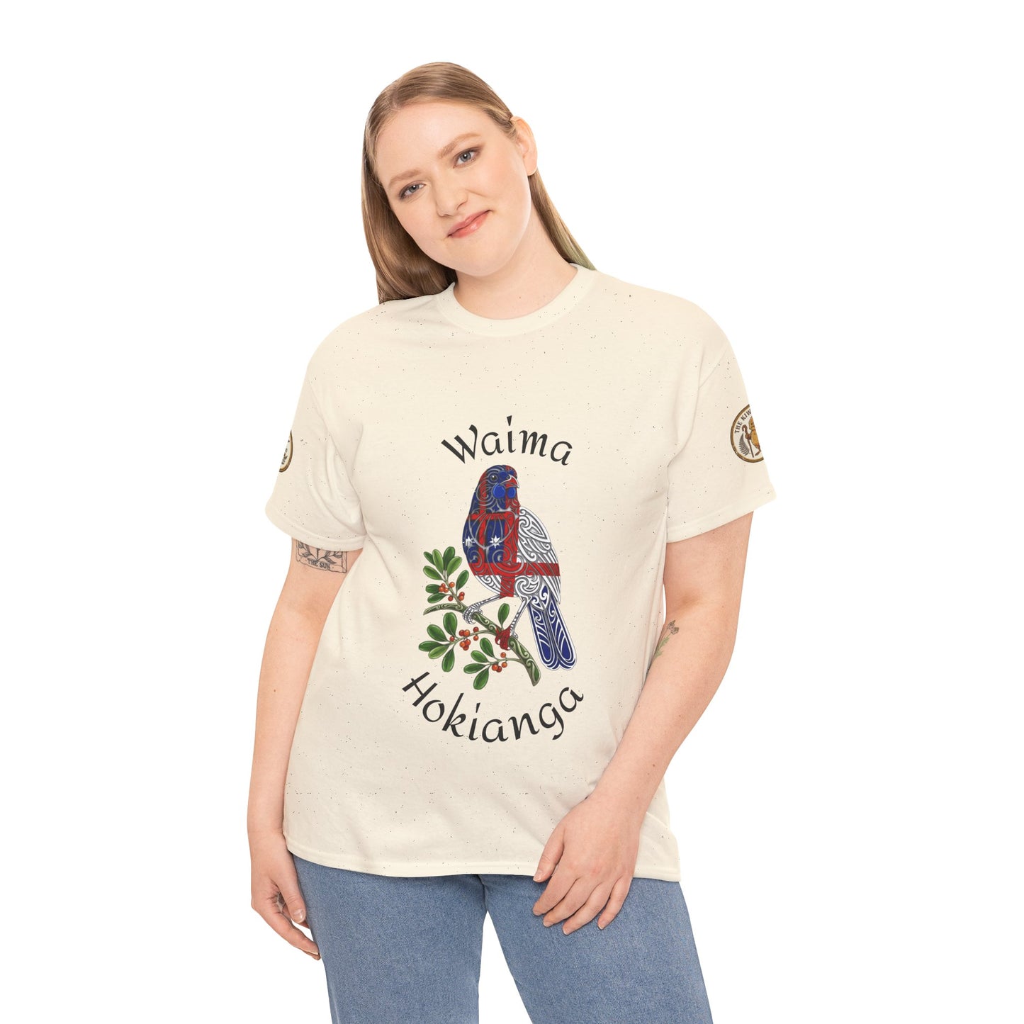 Cream T-shirt on woman model with bird graphic, green leaves, and "Hokianga" text