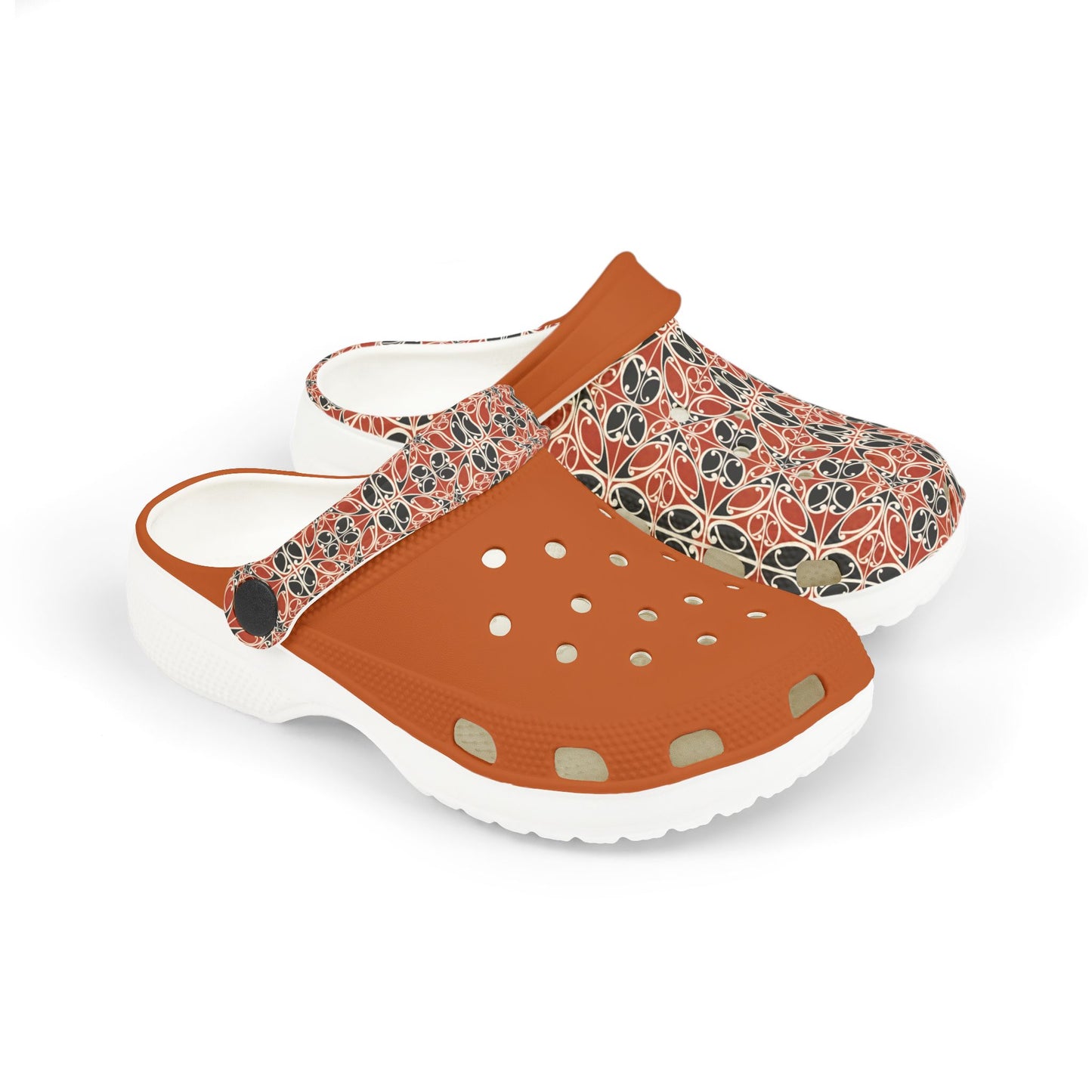 Māoritanga slide clogs with patterned upper, tan strap, and white cushioned sole